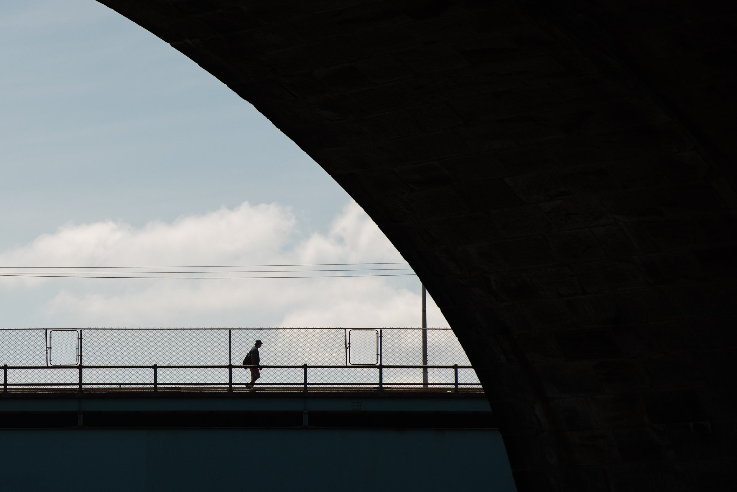   A person walks across the Girard Avenue Bridge above the Schuylkill River on Saturday, Sept. 10, 2022.   