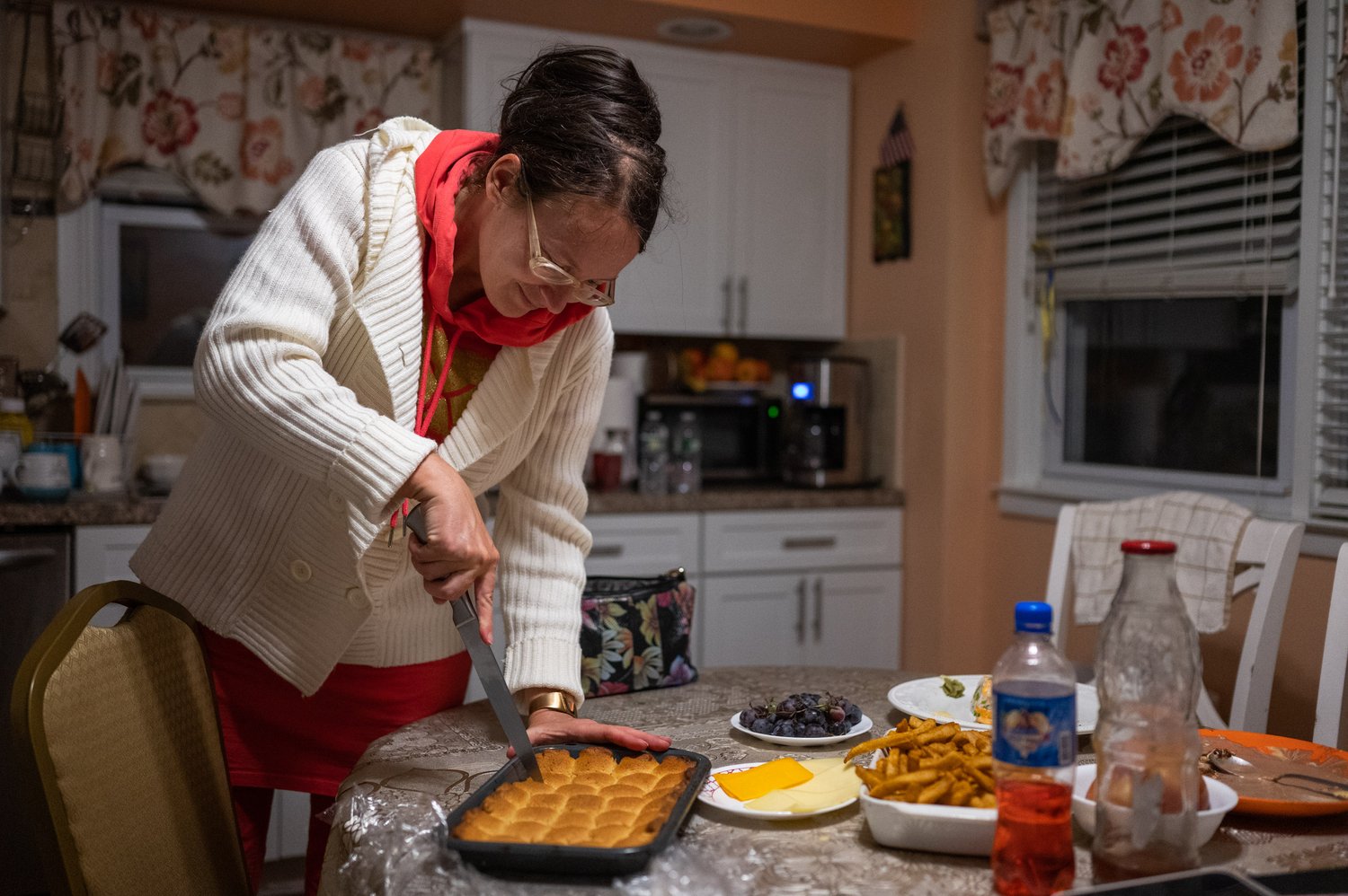   Veronica Matviienko cuts out a tray of Ukrainian cookies on Wednesday, Oct. 31, 2022.  