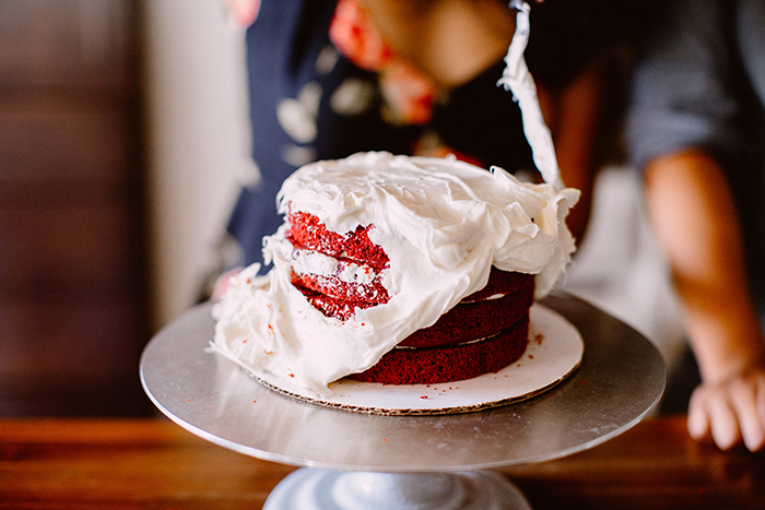 Frosting a red velvet cake