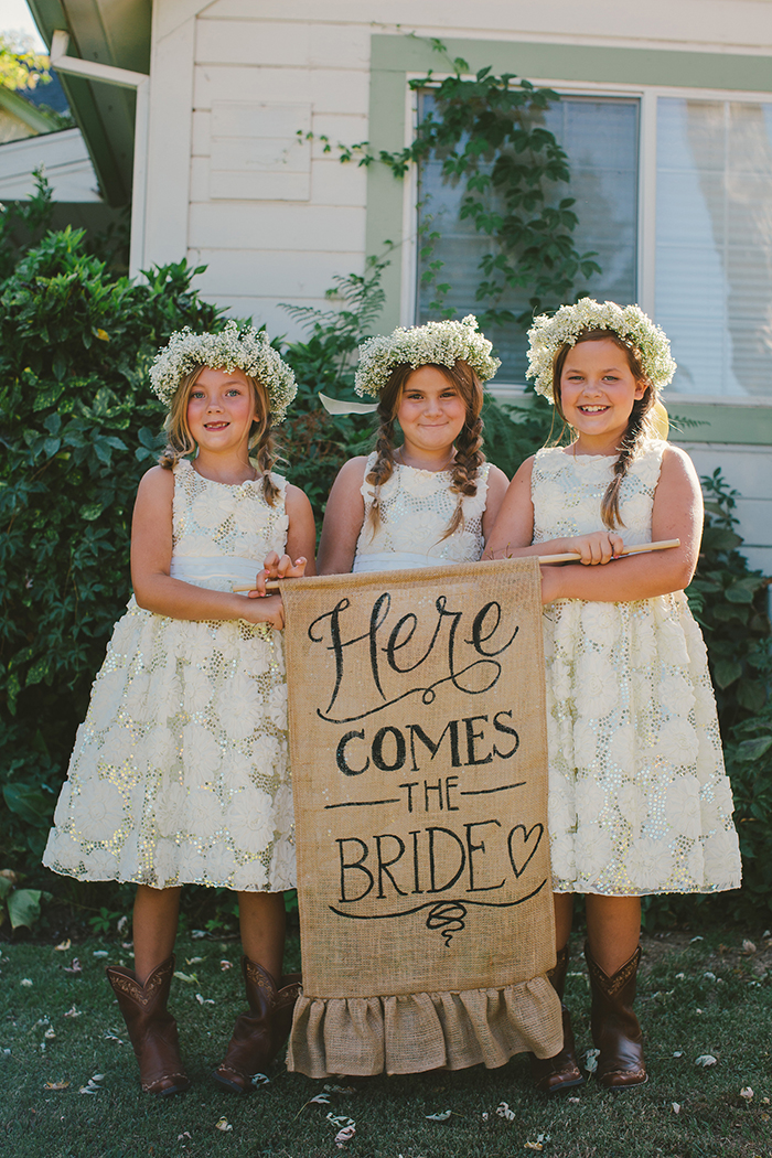 Flower girls and a rustic banner