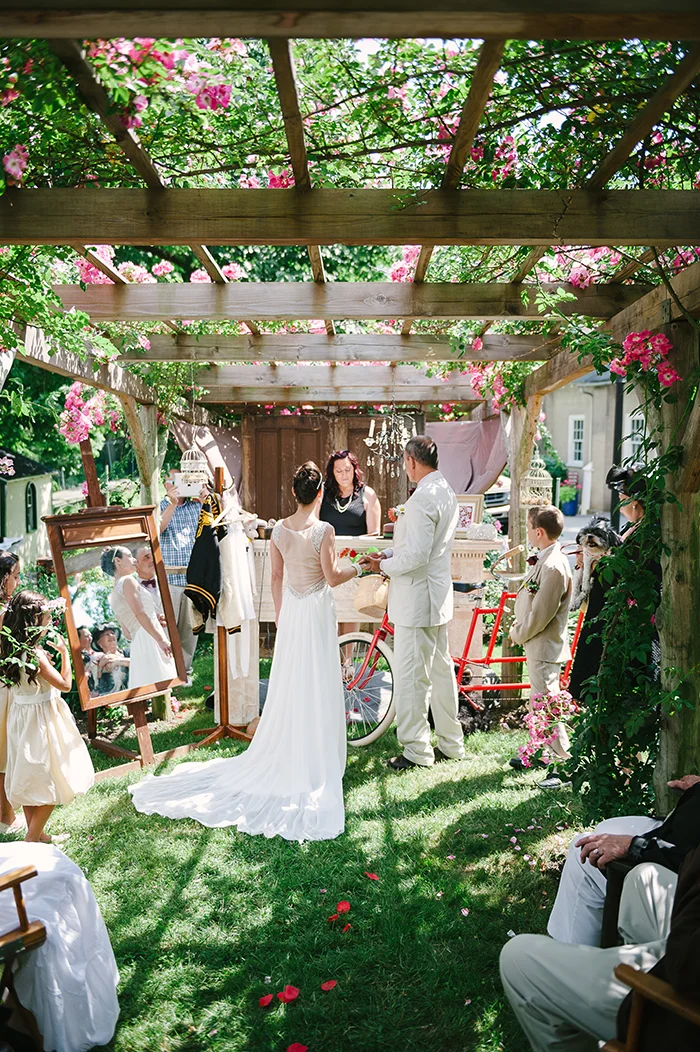 Rustic red outdoor wedding ceremony with a tandem bike!