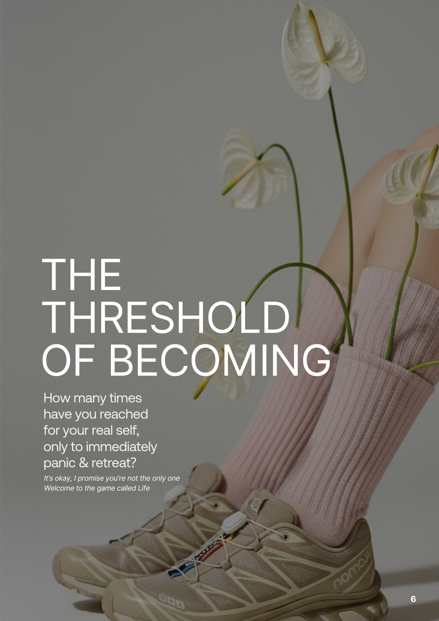 A person wearing pink socks and beige sneakers with white laces, holding a pink container with white flowers inside.