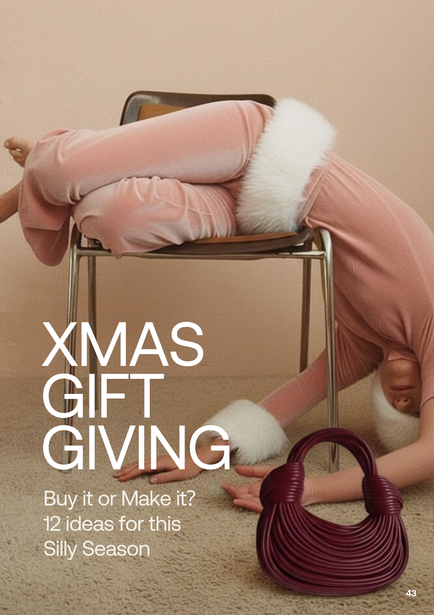 A person dressed in pink pajamas with white furry trim is bending back over a chair, with their head and chest upside down on the floor, hands on the carpet, and legs resting on the chair. The scene is in a room with beige walls and carpet. There is 