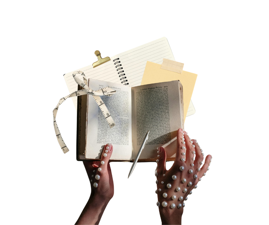 Hands with pearl-adorned fingers holding an open Bible surrounded by notebooks, a ruler tied with cloth, notes, and a pen.