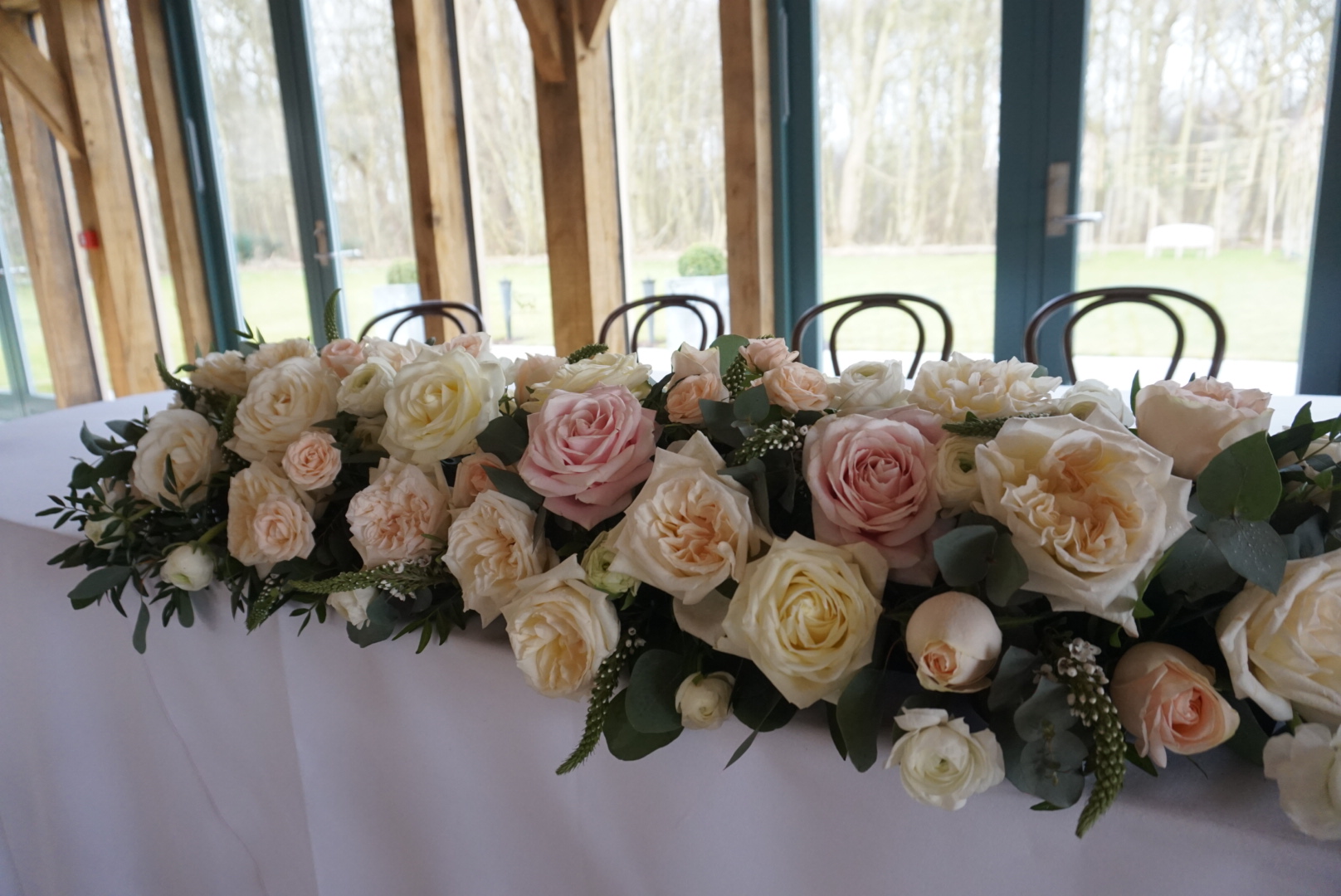  Rose wedding table arrangement at Hazel Gap Barn, Nottinghamshire. 