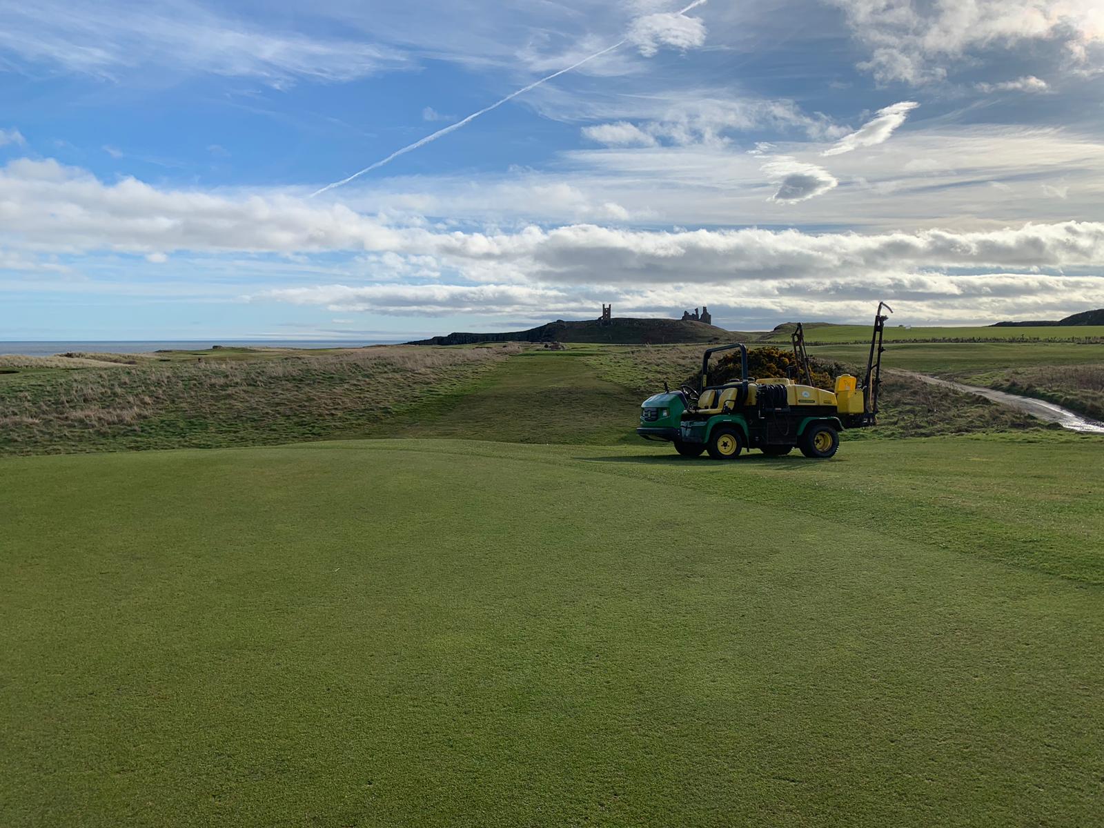 Alex out spraying the greens making sure we make the most of the weather!