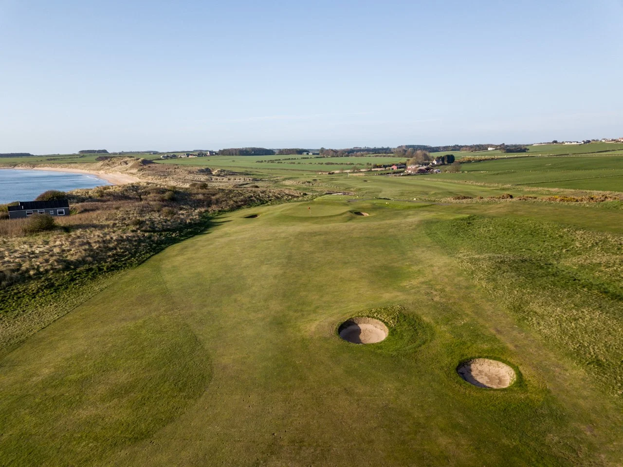 Aerial view of the links at Dunstanburgh Castle Golf Course with Embleton Bay beyond