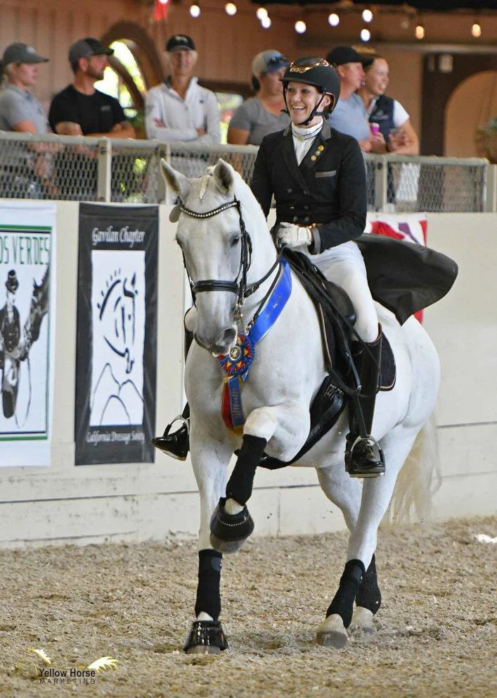 Lindsey Schulz and Delia 87 celebrate their win in the Intermediaire Freestyle on the first day of the Great American Insurance Group/USDF Region 7 Championships, held as part of the 2019 California Dressage Society Championship Show in Burbank. Photo: Jennifer M. Keeler/Yellow Horse Marketing.