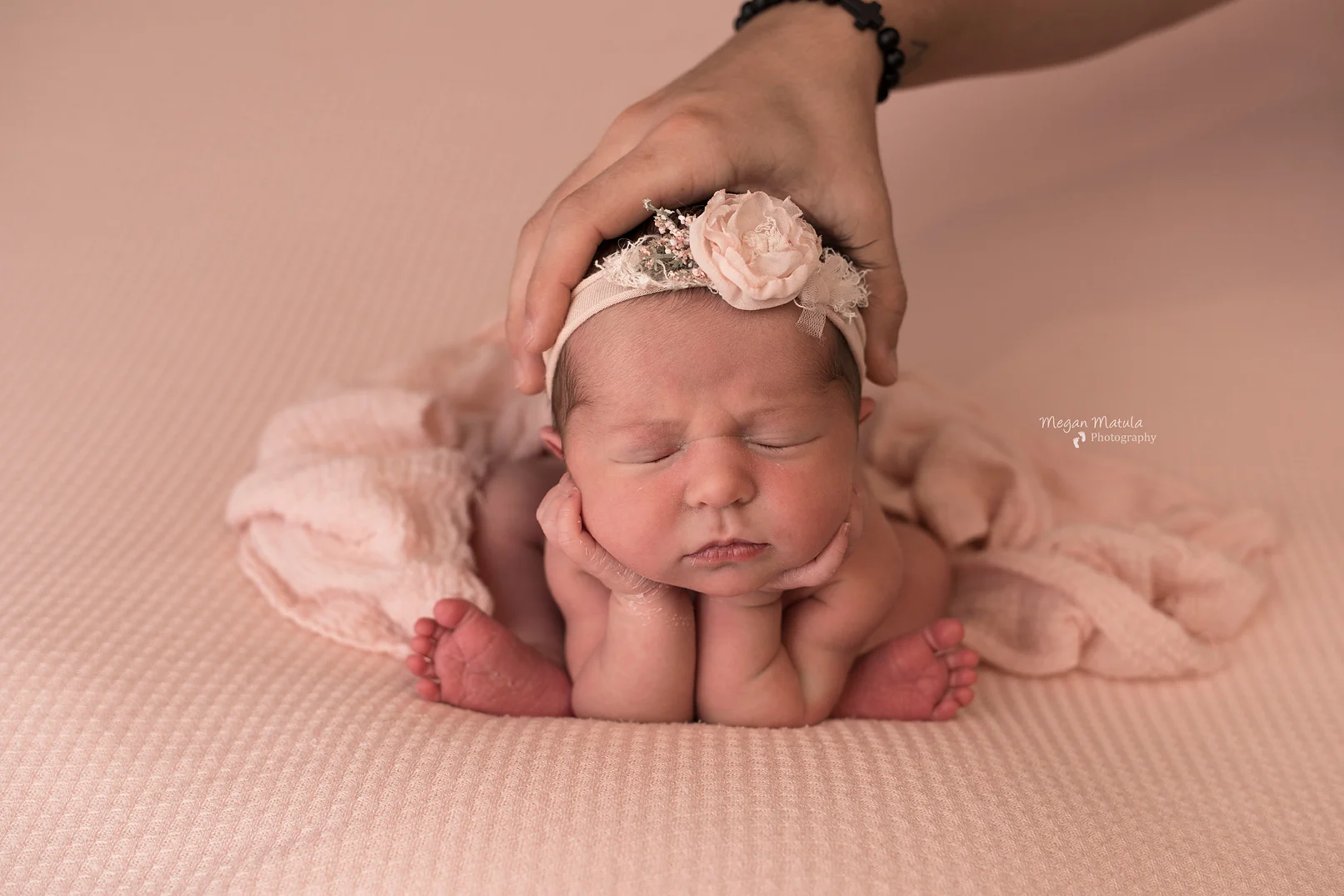 Dad supporting baby’s head.