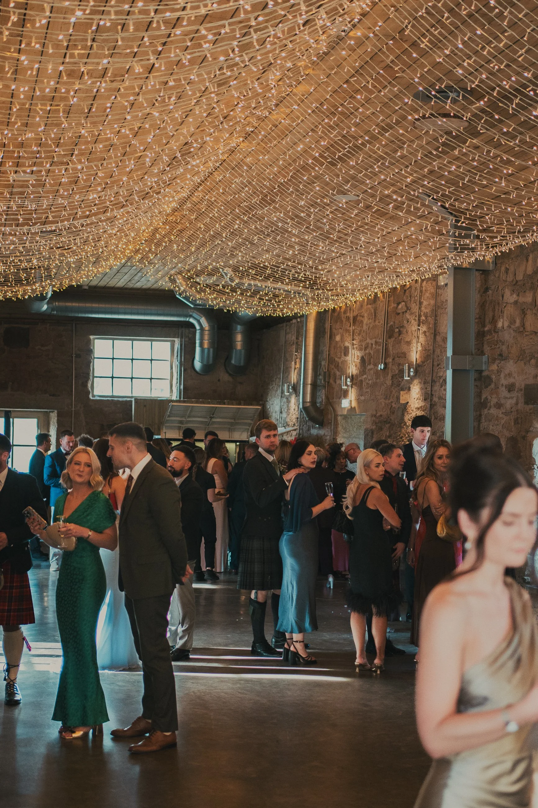 Wedding guests mingling during the drinks reception at Falside Mill
