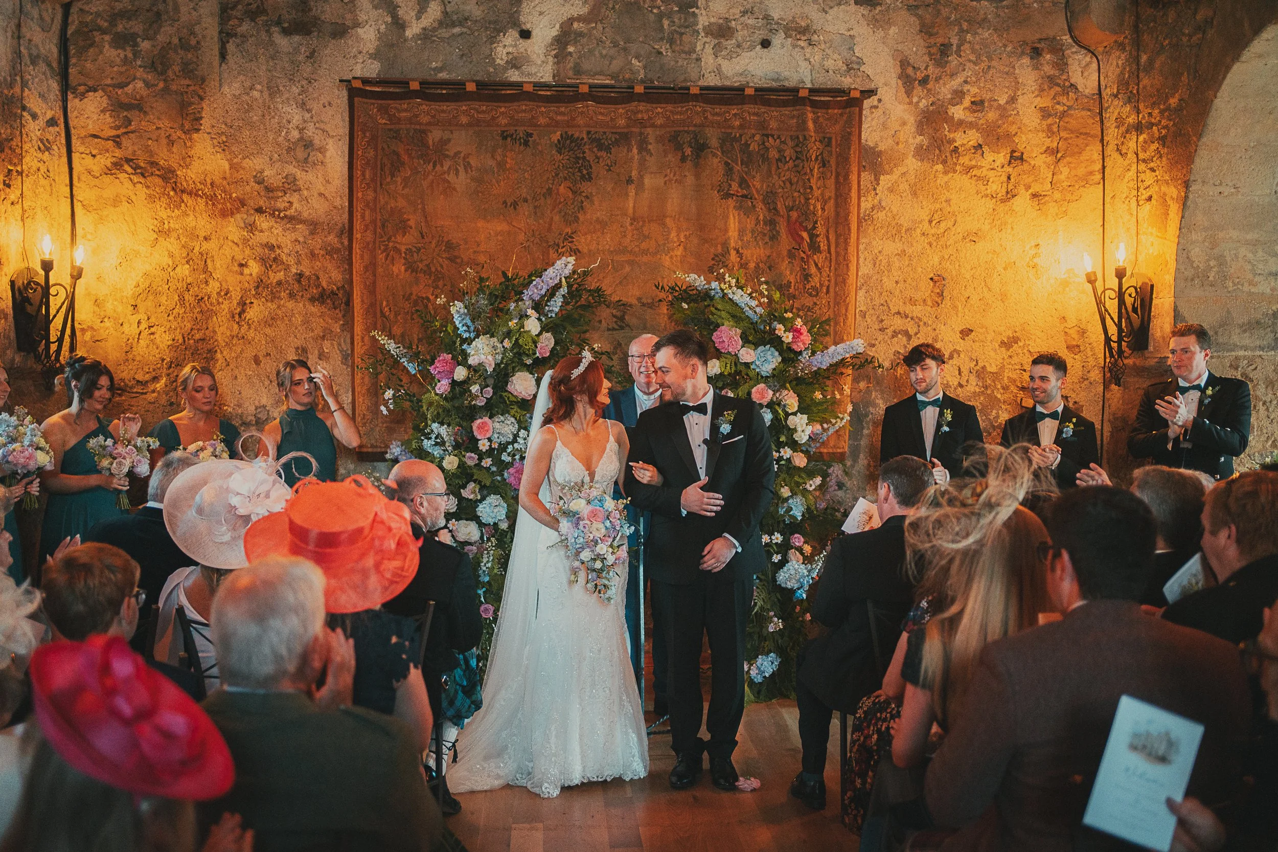 Newly married bride and groom walking back down the aisle after their ceremony at Dundas Castle.