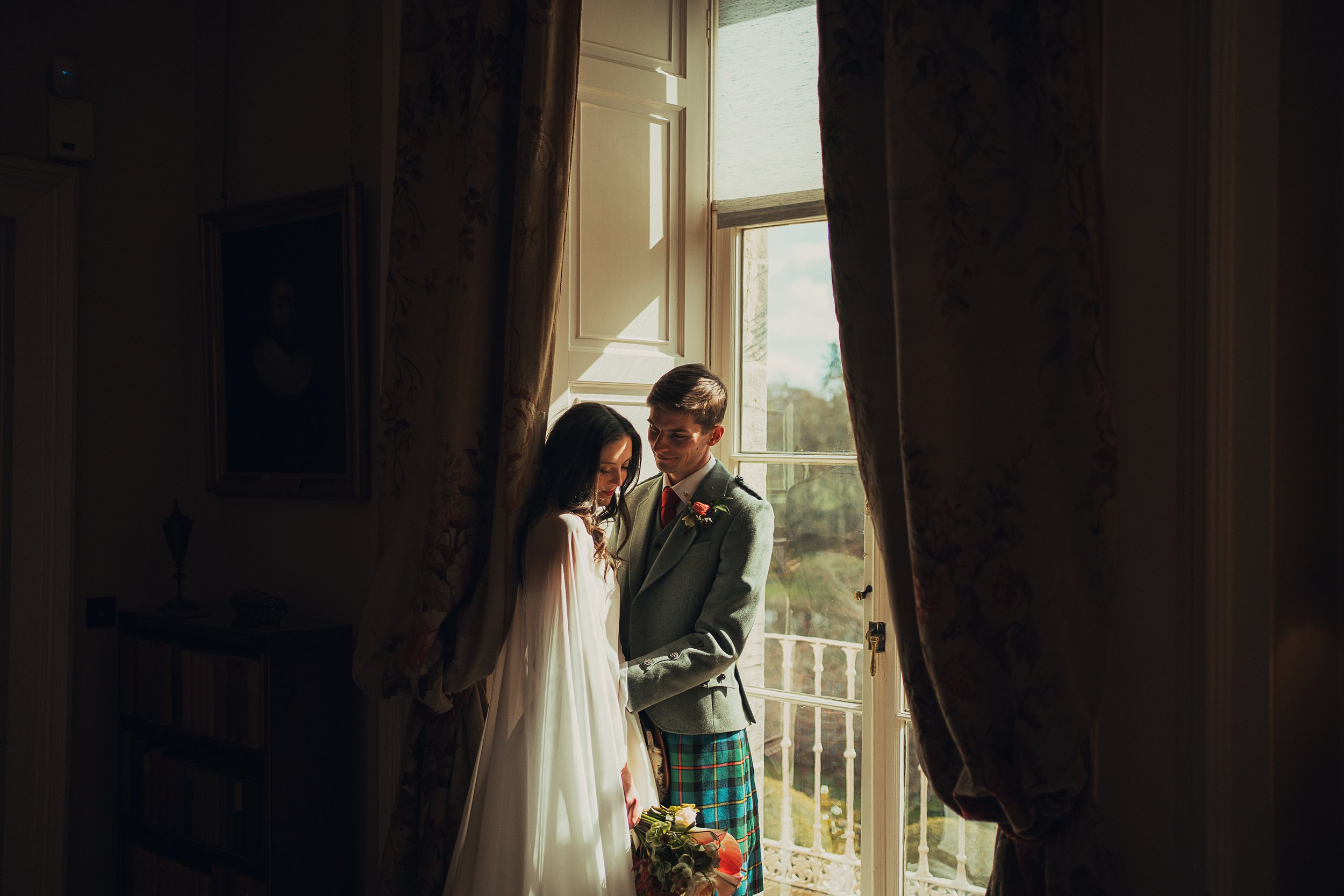 couple-window-light-winton-castle-wedding.jpg