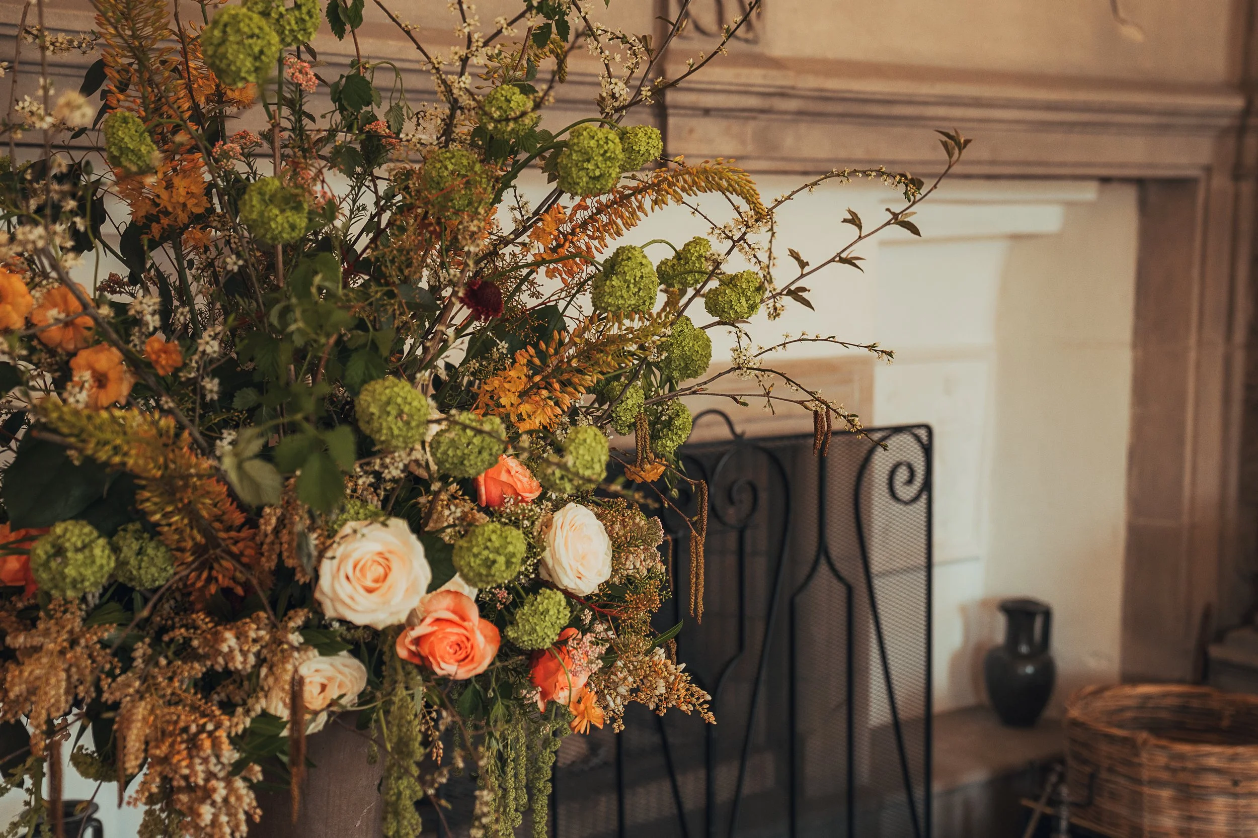 wedding-flowers-fireplace-winton-castle-peach-roses.jpg