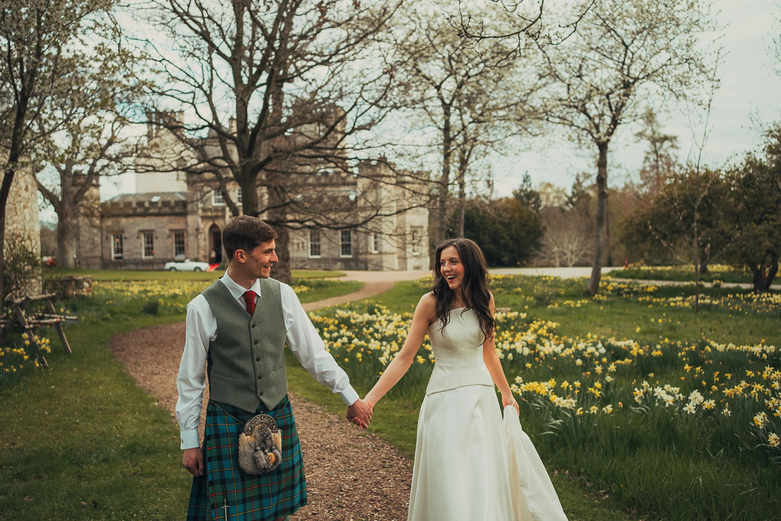couple-laughing-driveway-winton-castle-wedding.jpg