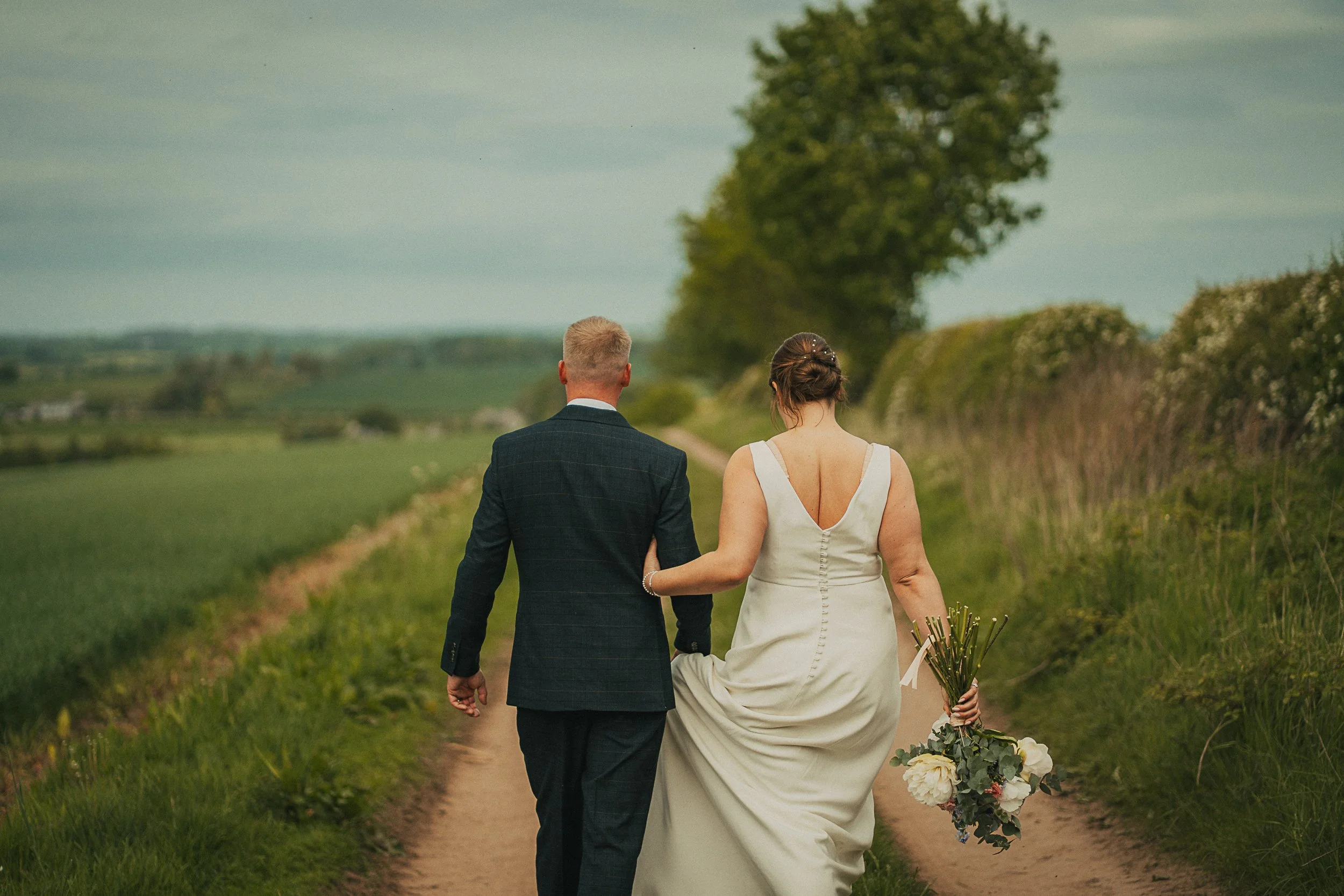couple-walking-scottish-borders-farm-wedding.jpg