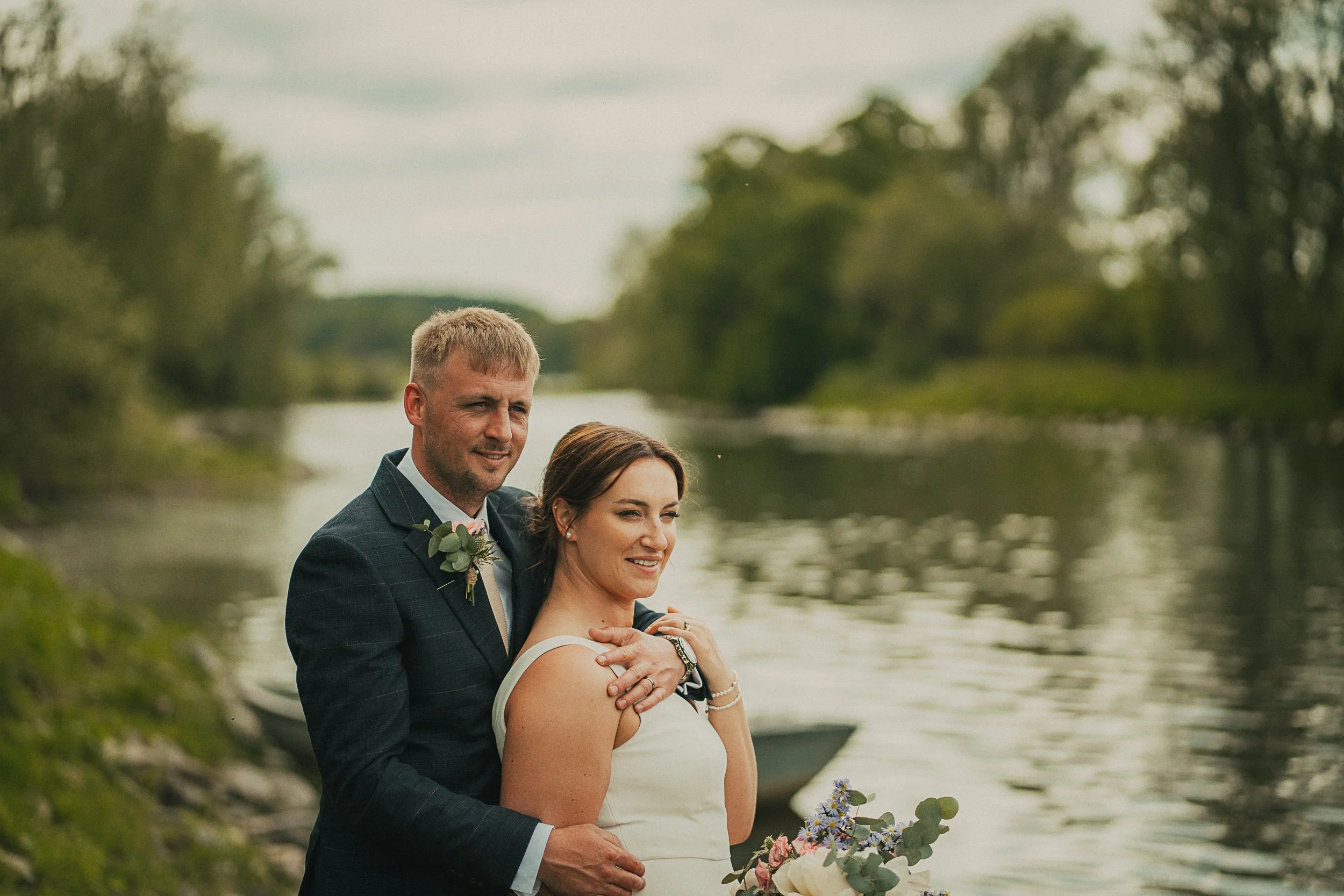 Evening wedding portraits by the River Tweed during golden hour at Libby and Nathan's family farm wedding in the Scottish Borders.
