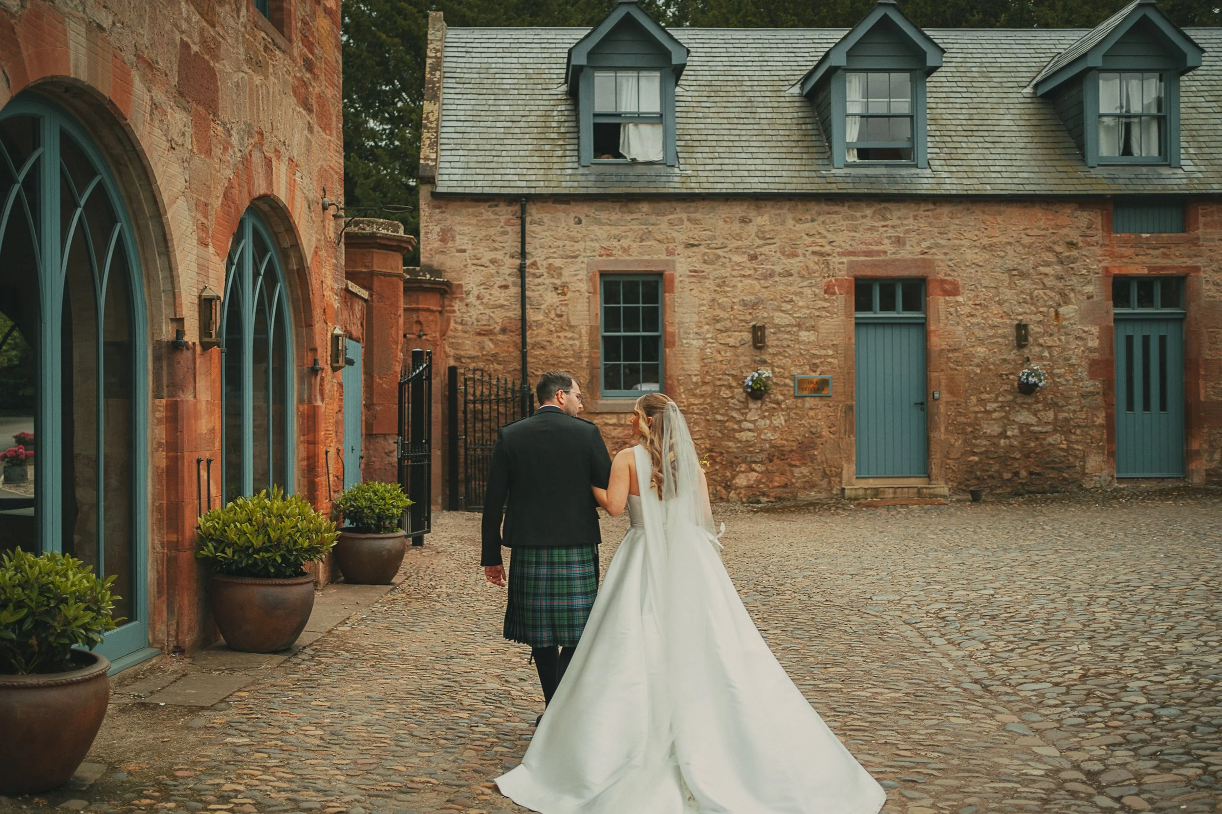 broxmouth-courtyard-wedding-couple-walking.jpg