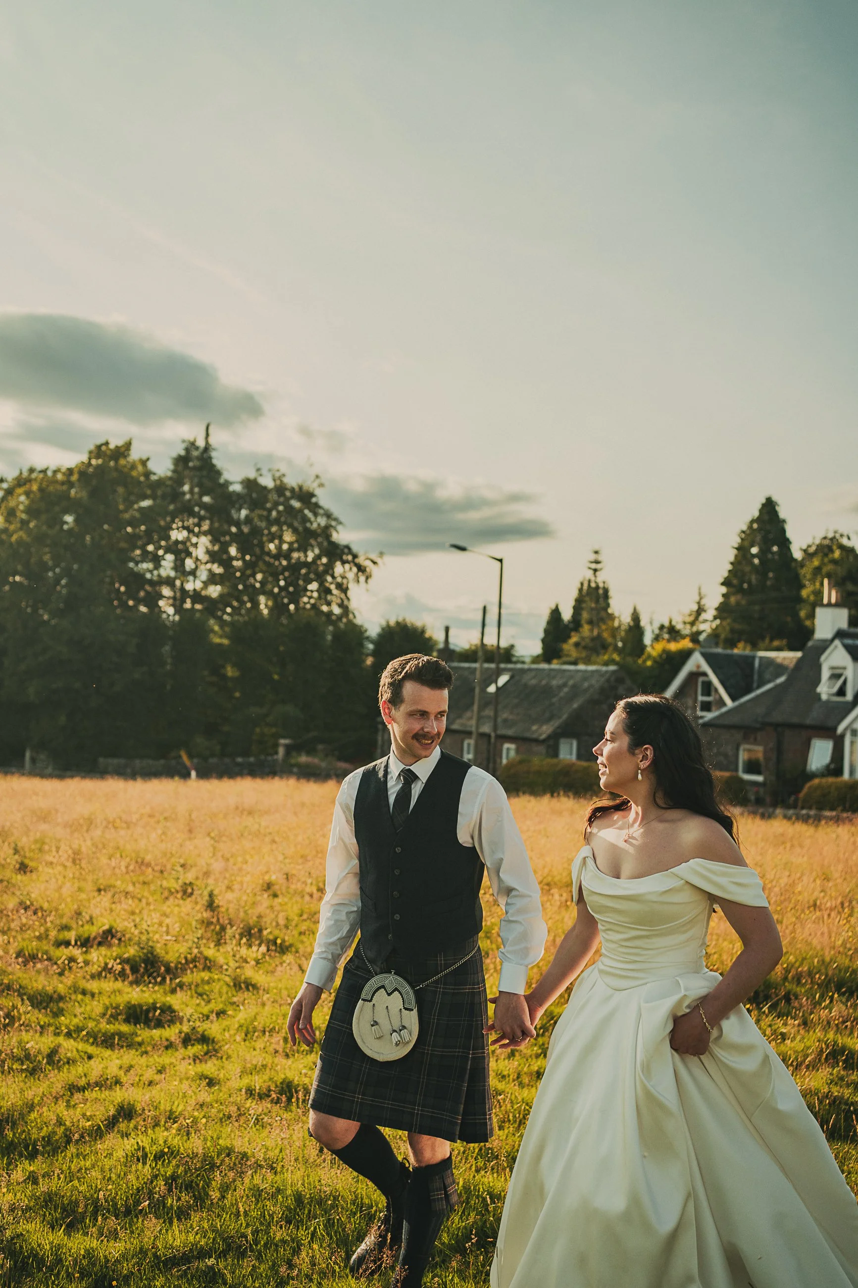 claire-adam-walking-holding-hands-field-killearn.jpg
