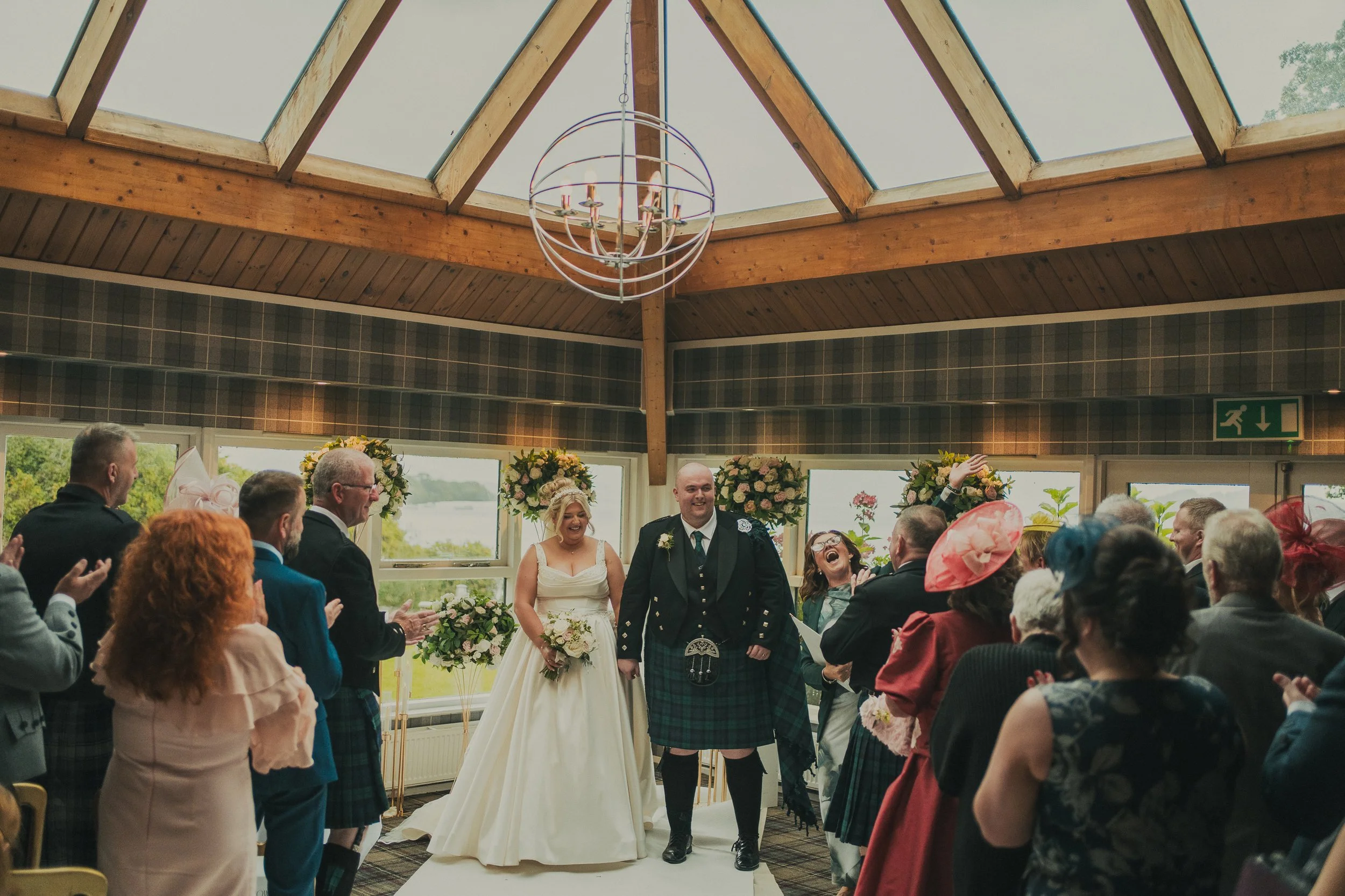 laura-nicky-the-cruin-loch-lomond-wedding-couple-ceremony-aisle.jpg
