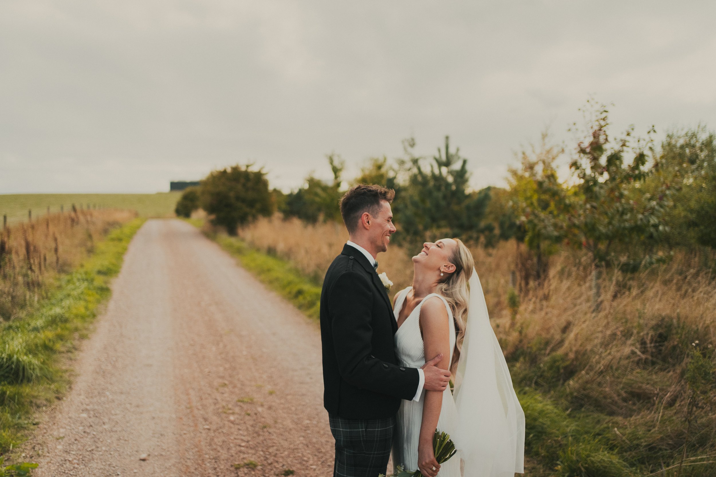 robyn-robbie-falside-mill-wedding-laughing.jpg