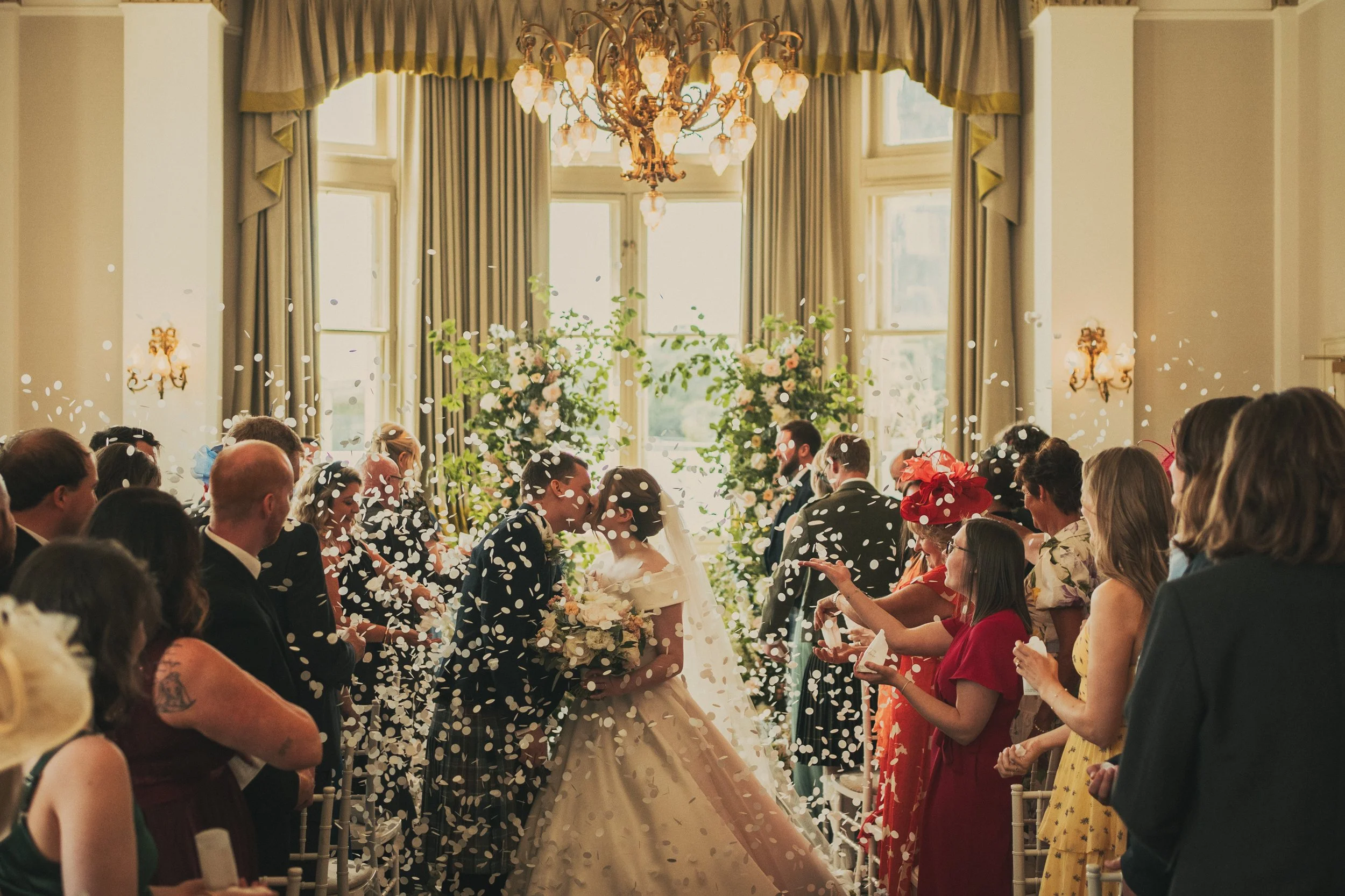 Alexandra and Gavin walking through confetti after their wedding ceremony at The Balmoral Hotel