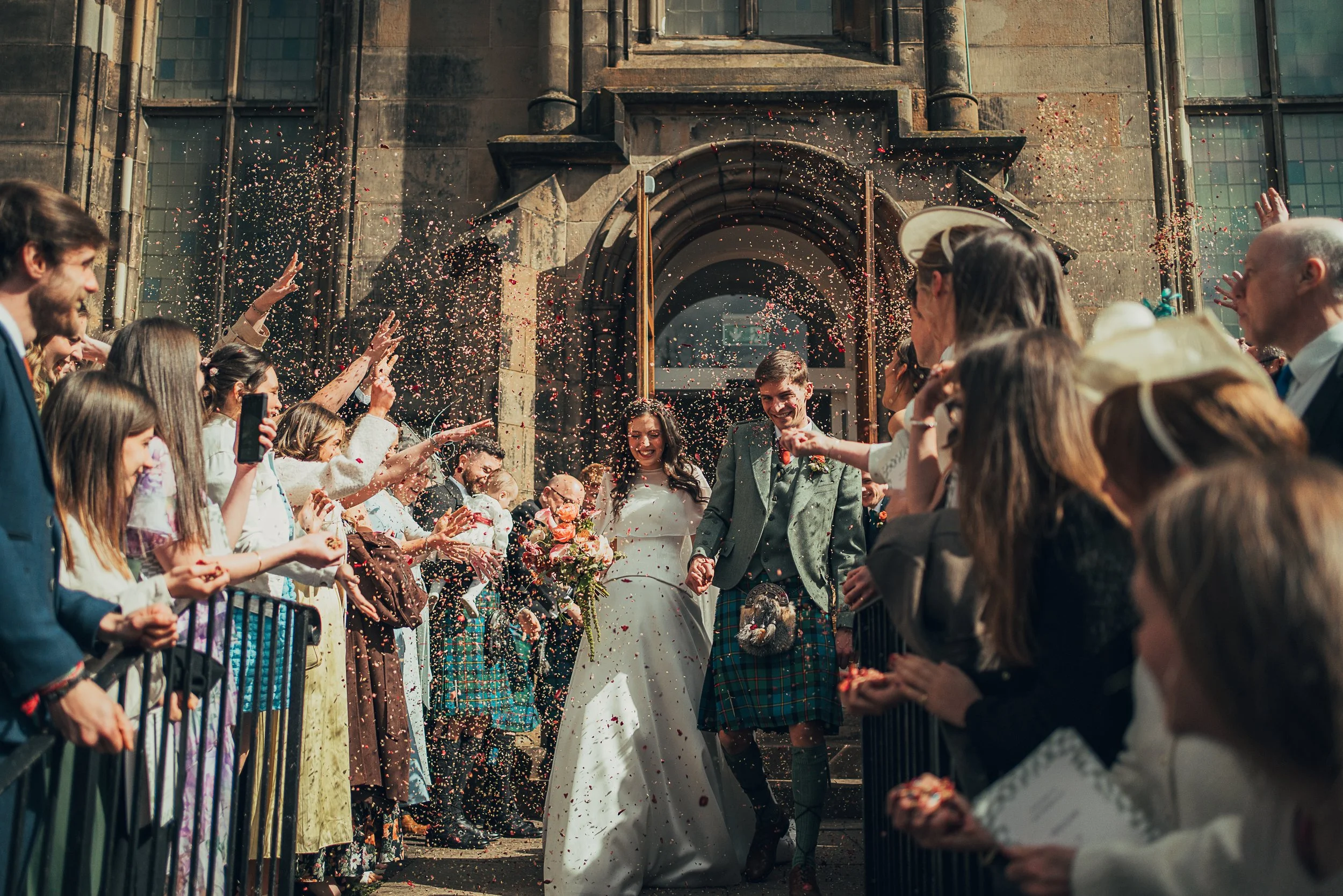 Confetti moment outside Chalmers Church in Edinburgh after the wedding ceremony