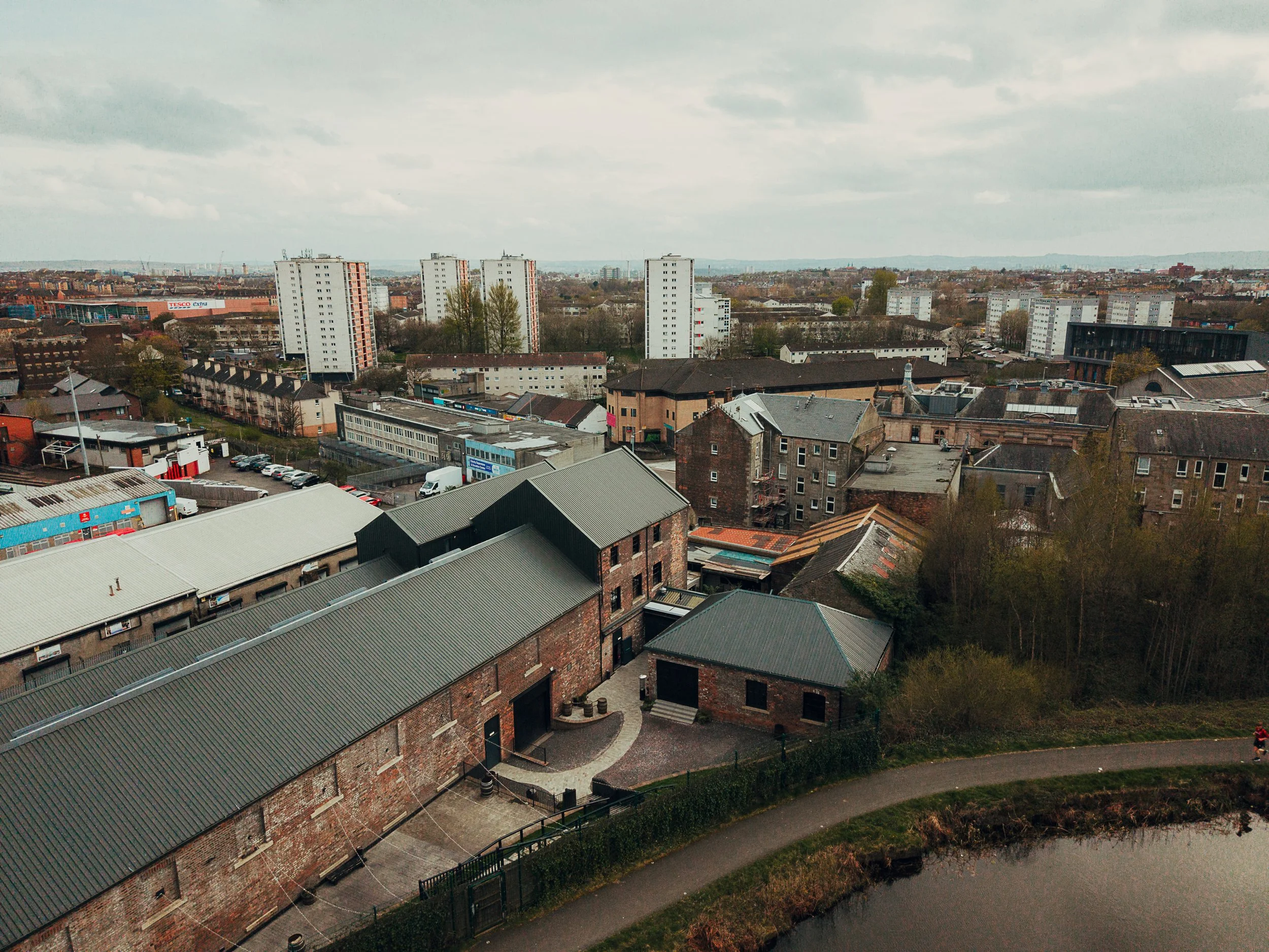 Aerial drone view of The Engine Works Glasgow beside canal showing industrial wedding venue exterior