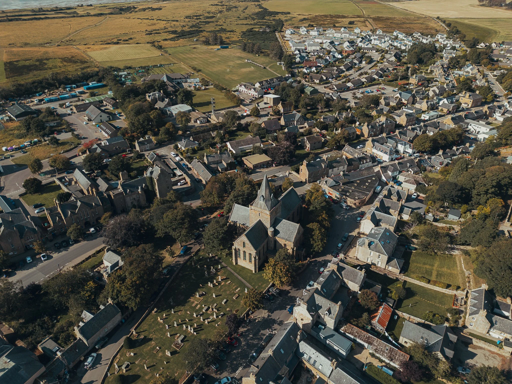 Aerial view of Dornoch Cathedral and the Highland landscape on a wedding day