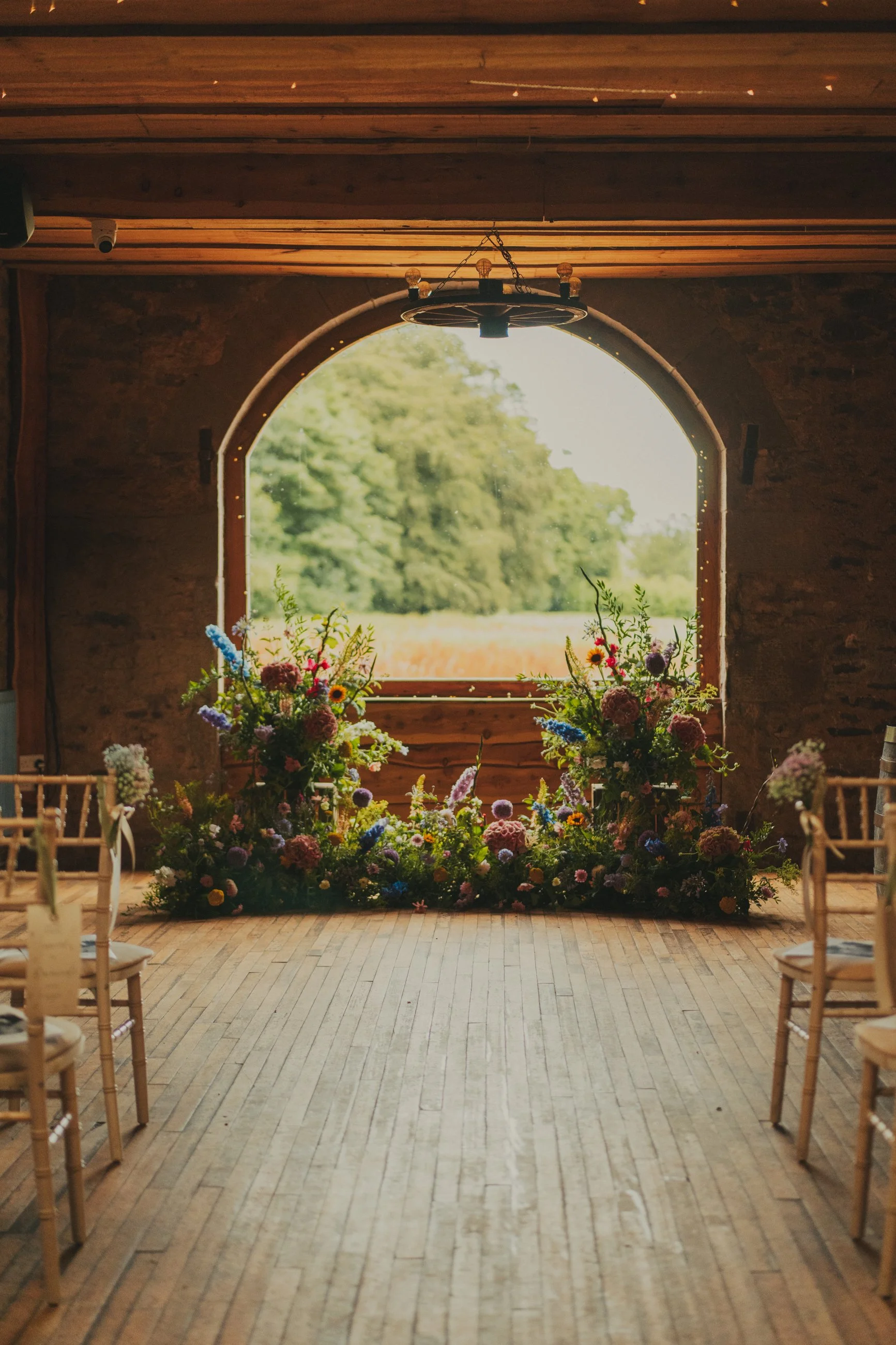Wedding ceremony aisle decorated with a wildflower centrepiece at Wedderlie House