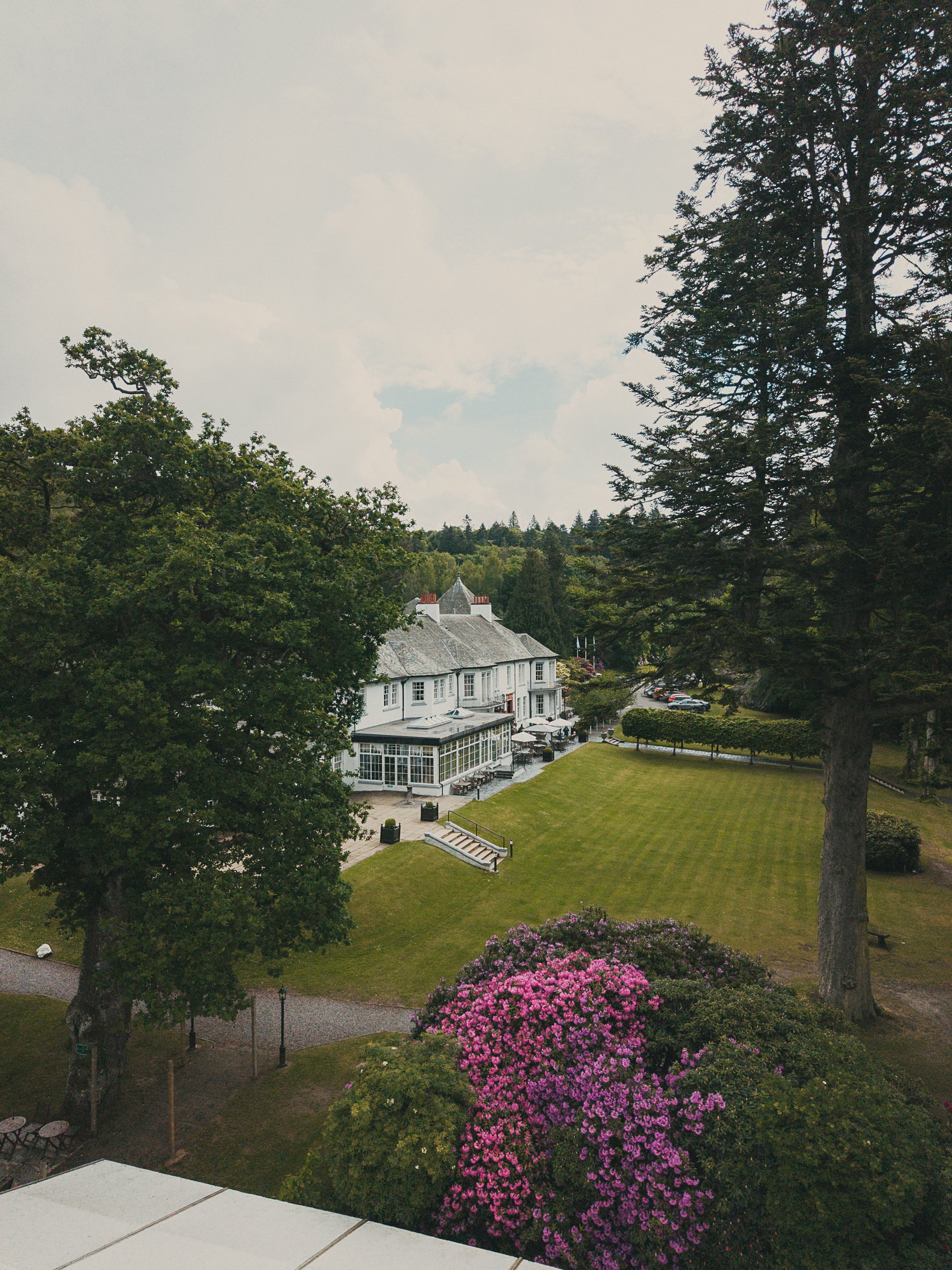Drone view of Dunkeld House Hotel surrounded by woodland in Perthshire, Scotland.