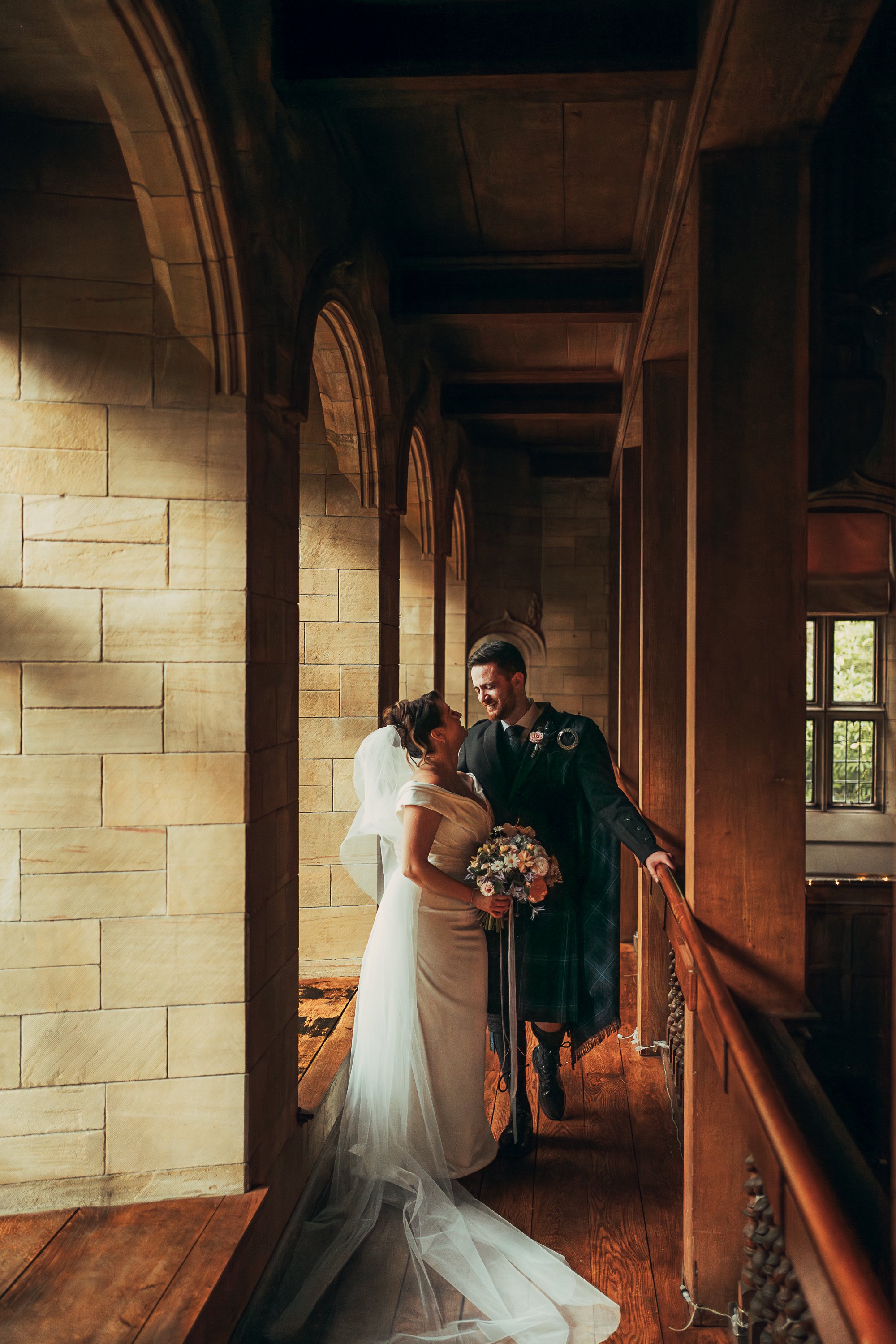 Bride and groom sharing a quiet moment on the balcony inside Achnagairn ballroom