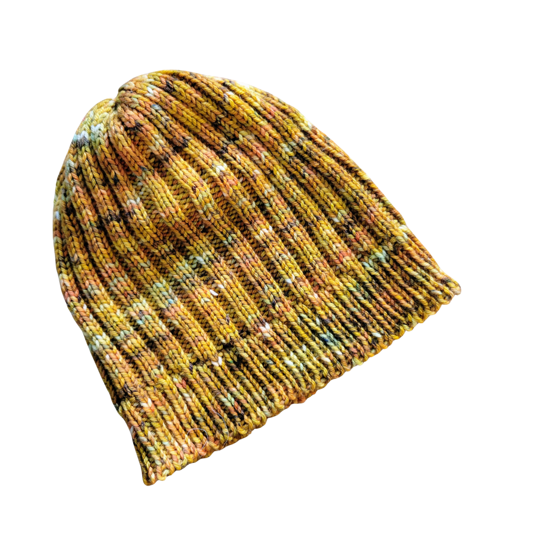 Colorful knitted beanie hat with yellow, orange, green, and black hues isolated on white background.