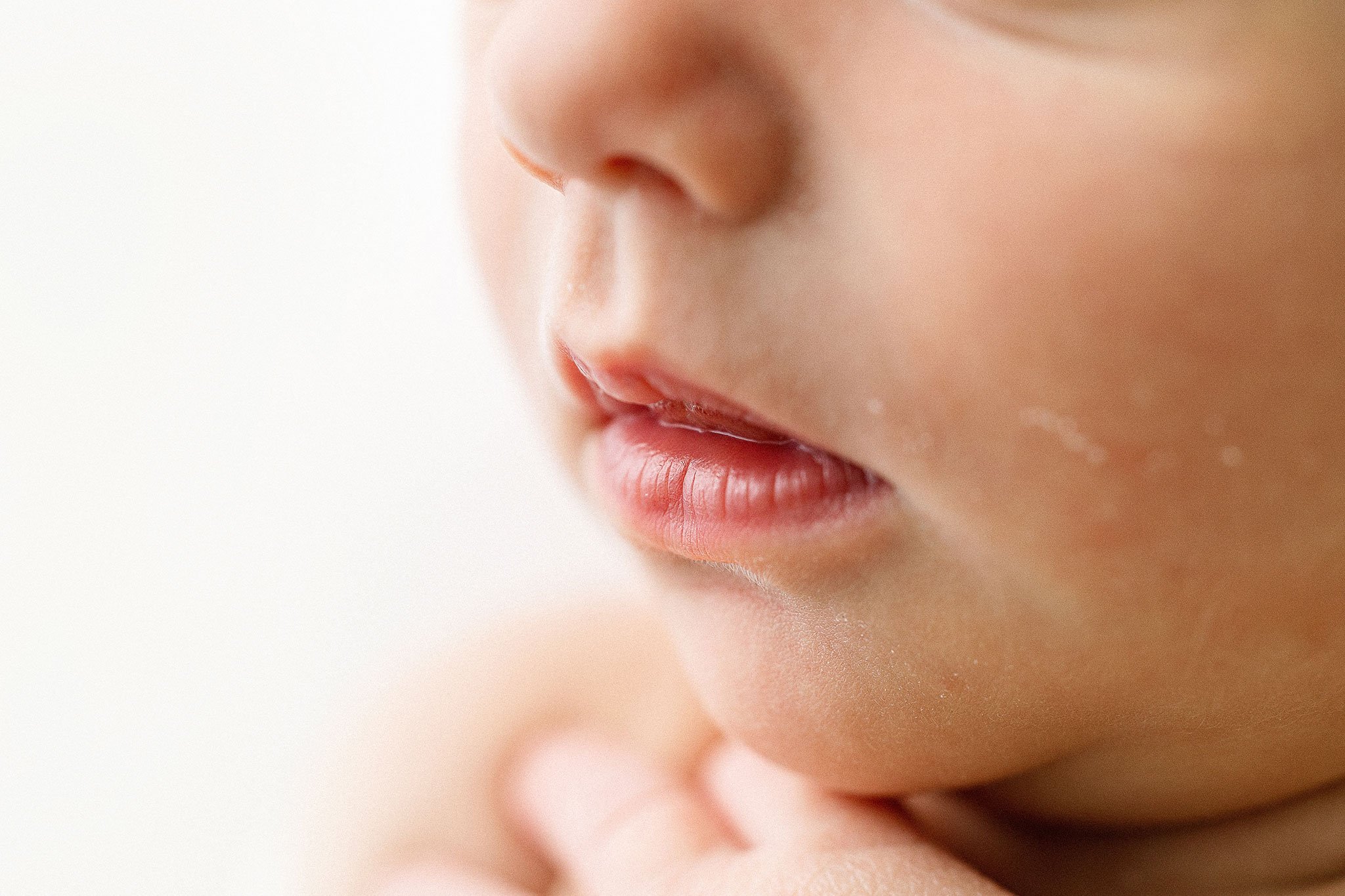 Close-up of a baby's lips and chin, soft focus