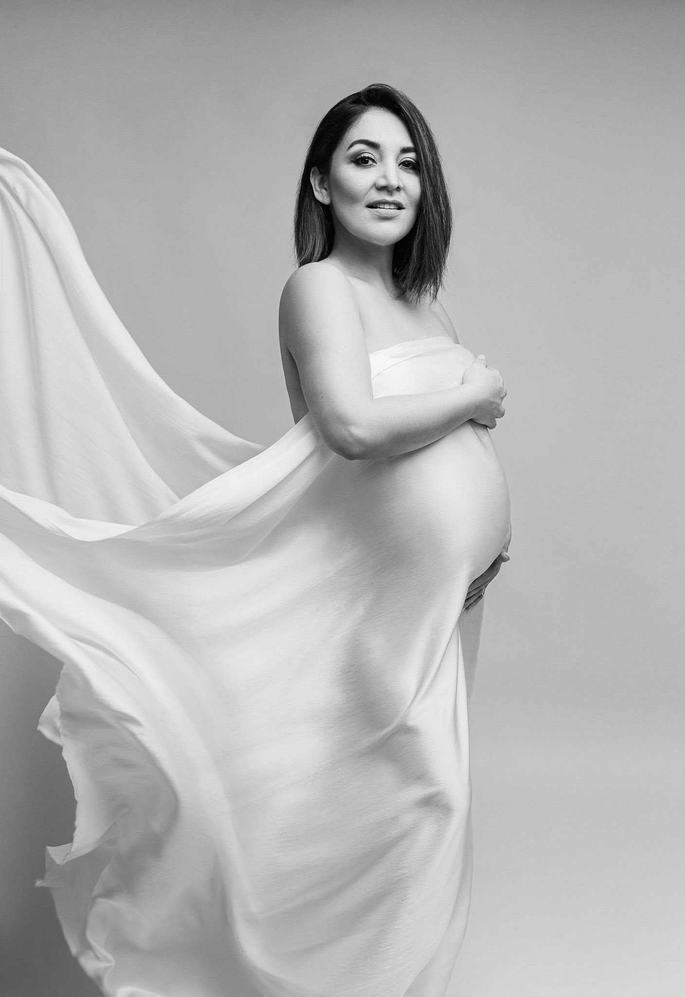 Pregnant woman in flowing fabric