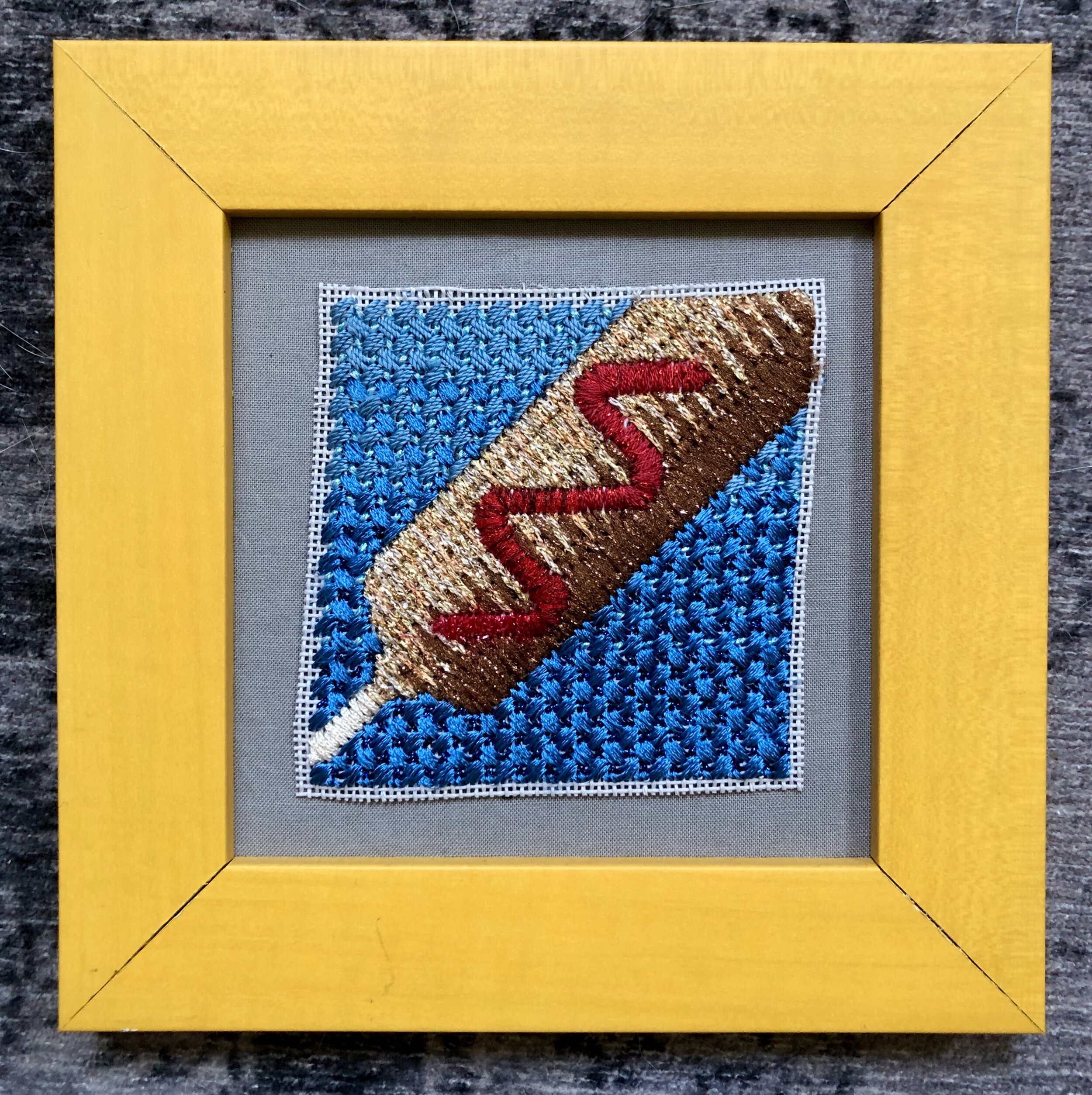   Corn Dog,  2019. Polyester &amp; cotton on needlepoint canvas. 3.5” x 3.5”. 