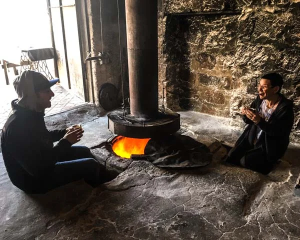 A tonir is a pretty great place to keep warm on cold mornings. Here, Ara and Marie Lou warm up with soorj and the fire on our visit to Argel.
