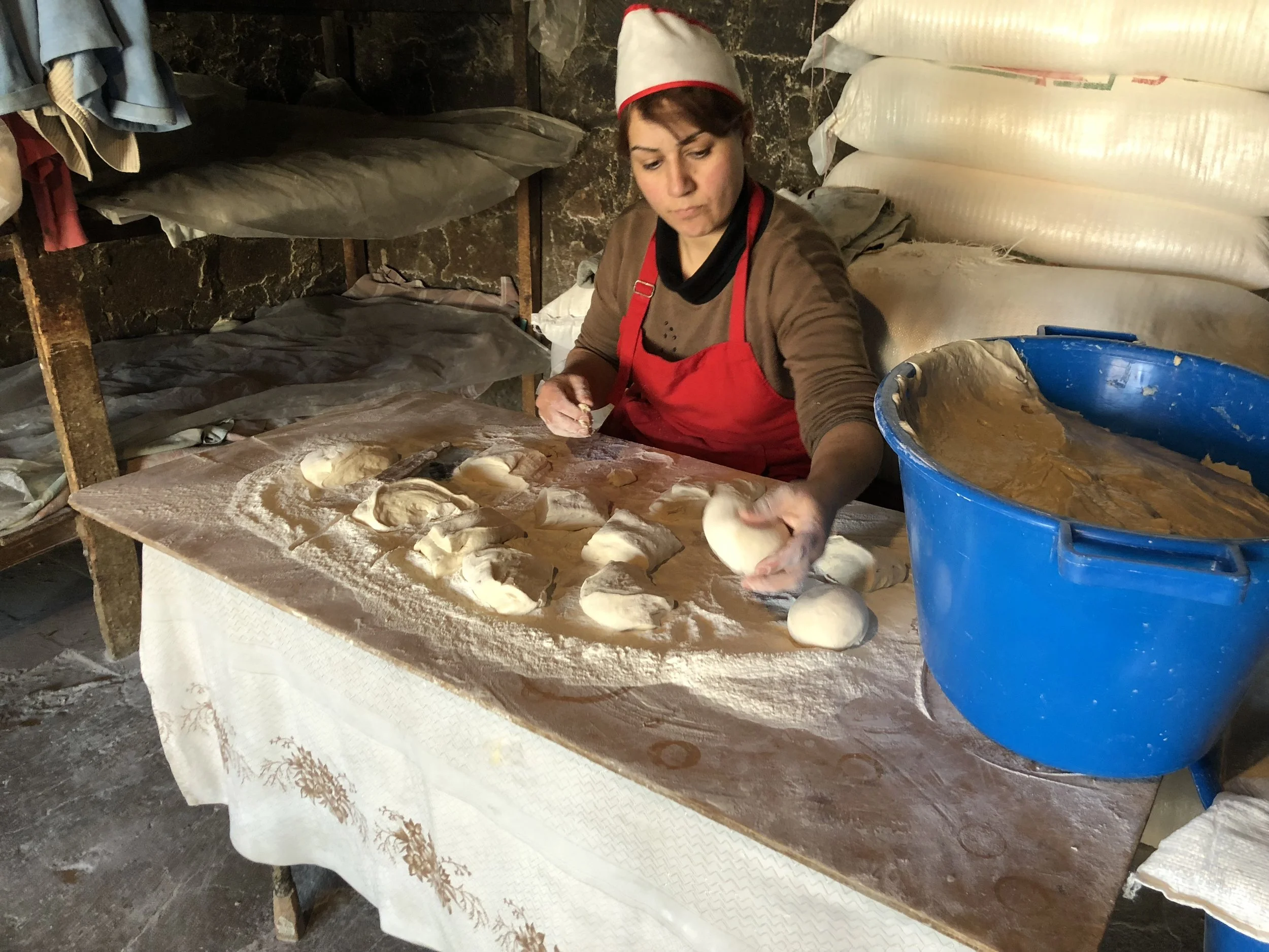 The woman who mixed the dough to make lavash was also responsible for portioning it out, which she could do by eye without the help of a scale.