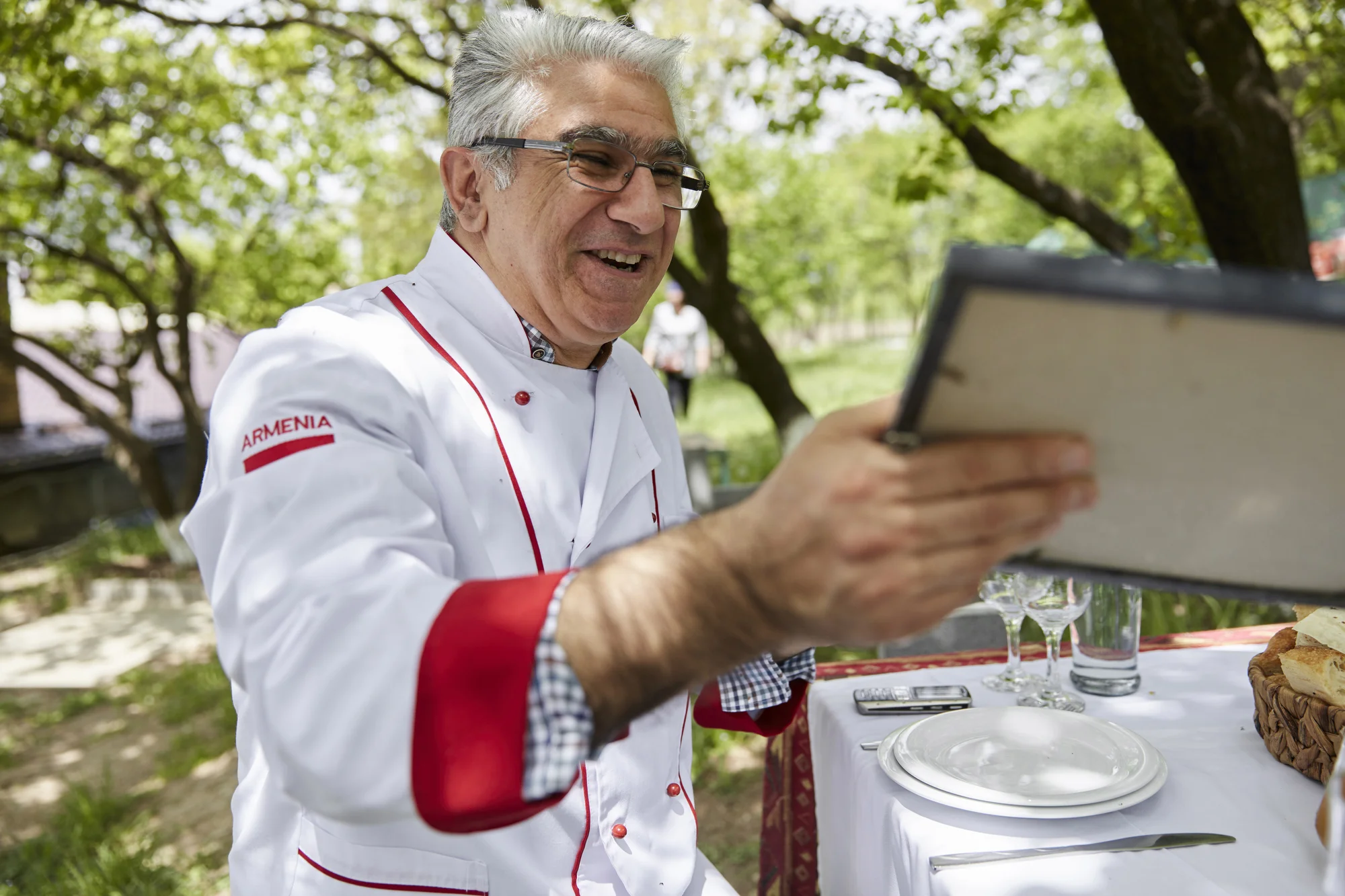 Armen Qefilyan holding the certificate naming him as the champion in a national khorovats competition in 2009.