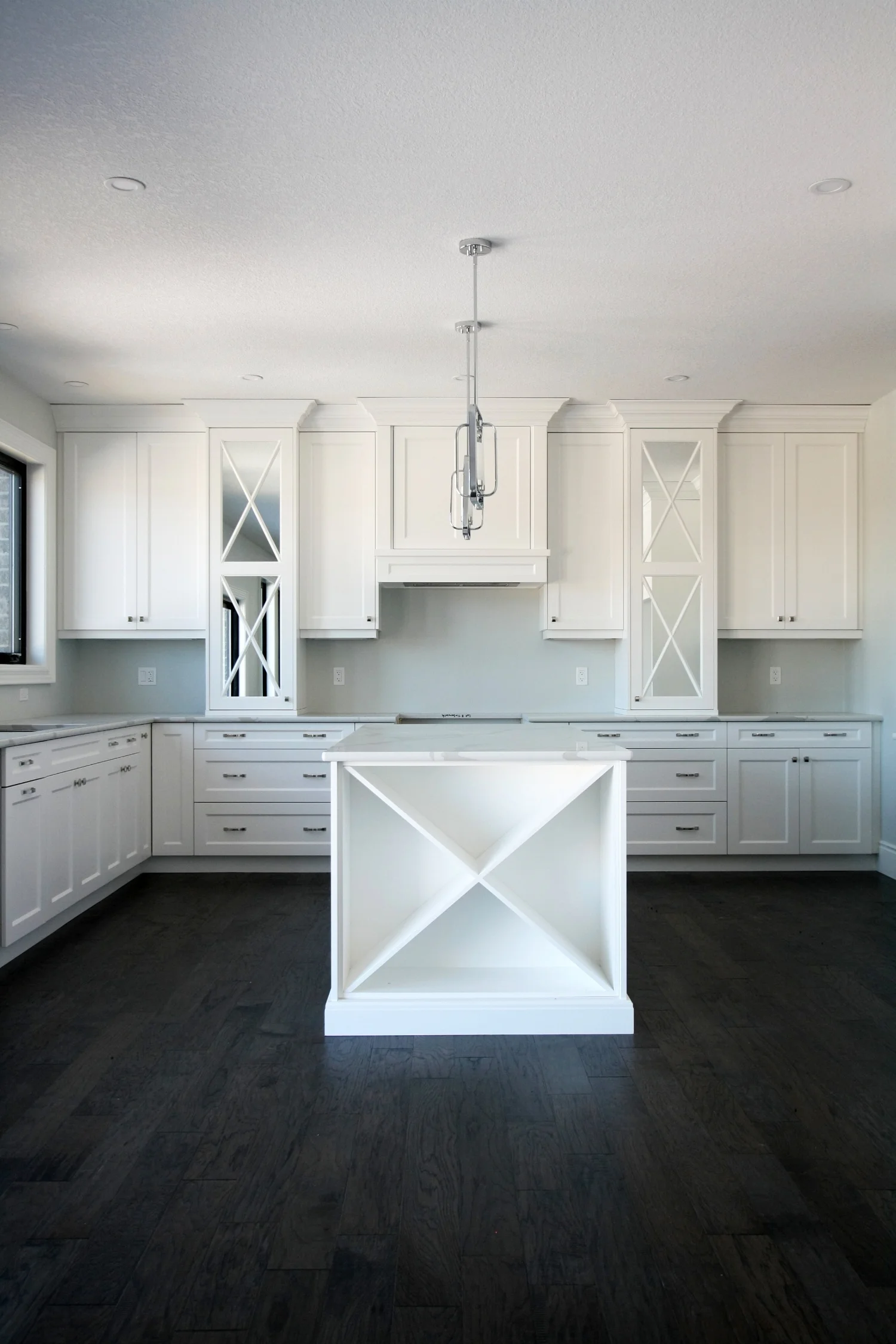 White kitchen with mirrored details and Island with wine storage