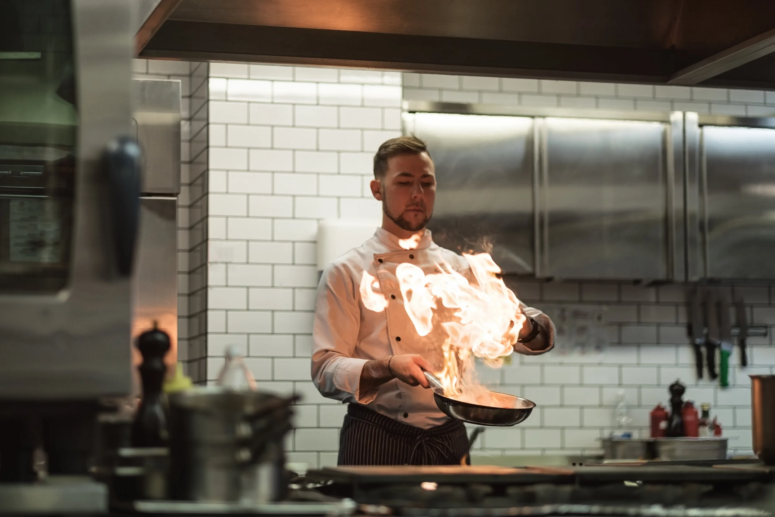 a-man-cooks-cooking-deep-fryers-in-a-kitchen-fire-PMZBQK7.jpg