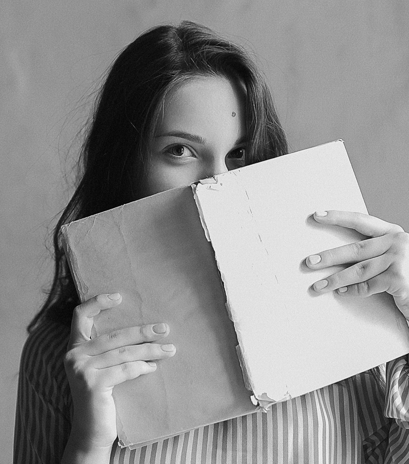 Girl peeking out over book pexels (2).jpeg