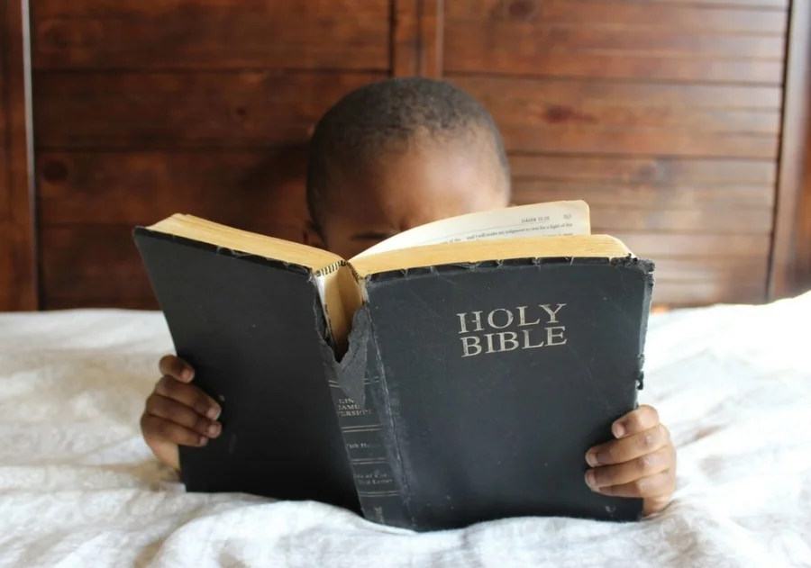 Bible boy on bed.jpeg