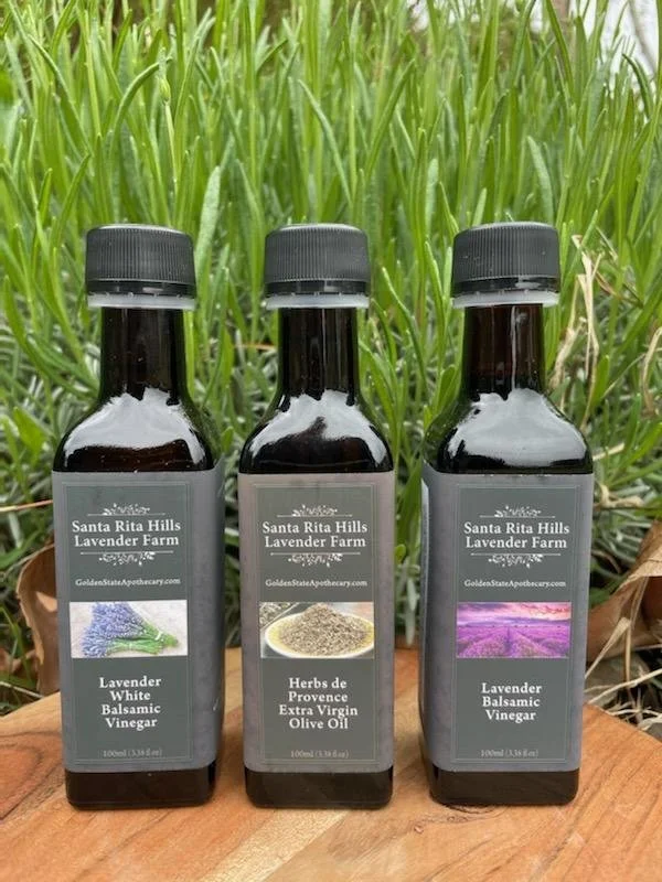 Culinary lavender bottles in front of a lavender plant at Santa Rita Hills Lavender Farm