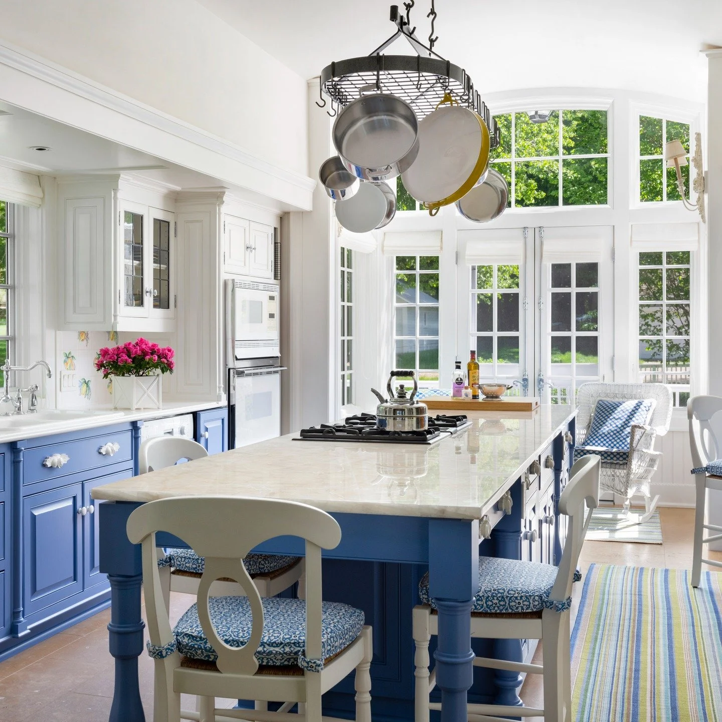 A carefully considered blue was used on the lower cabinetry in our Lake Okoboji renovation. We wanted to make a statement and create a mood that was calm, yet lively. With ample sunlight streaming in, we knew if there were a kitchen that could handle