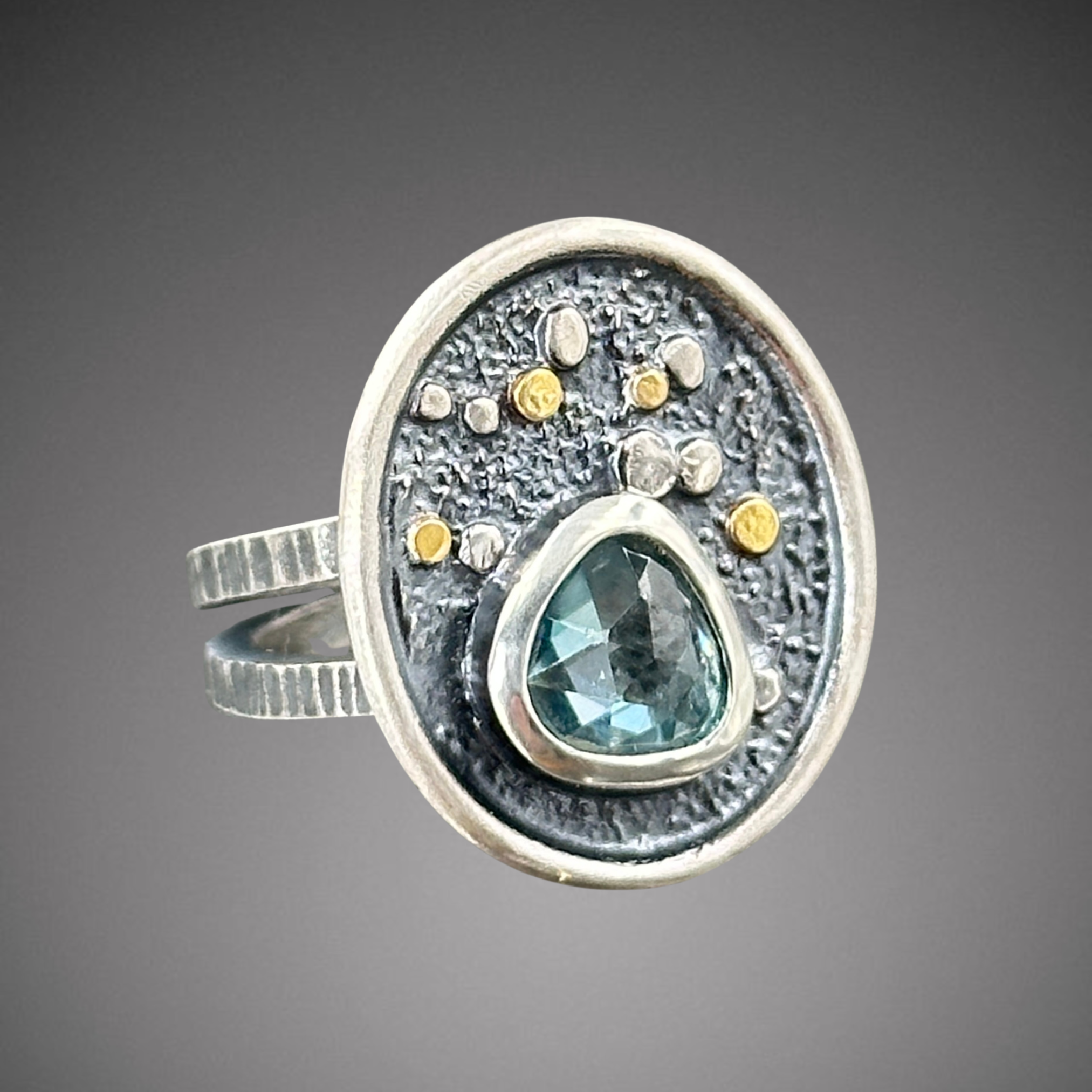 Lg Oasis ring with triangle blue zircon  (1).png