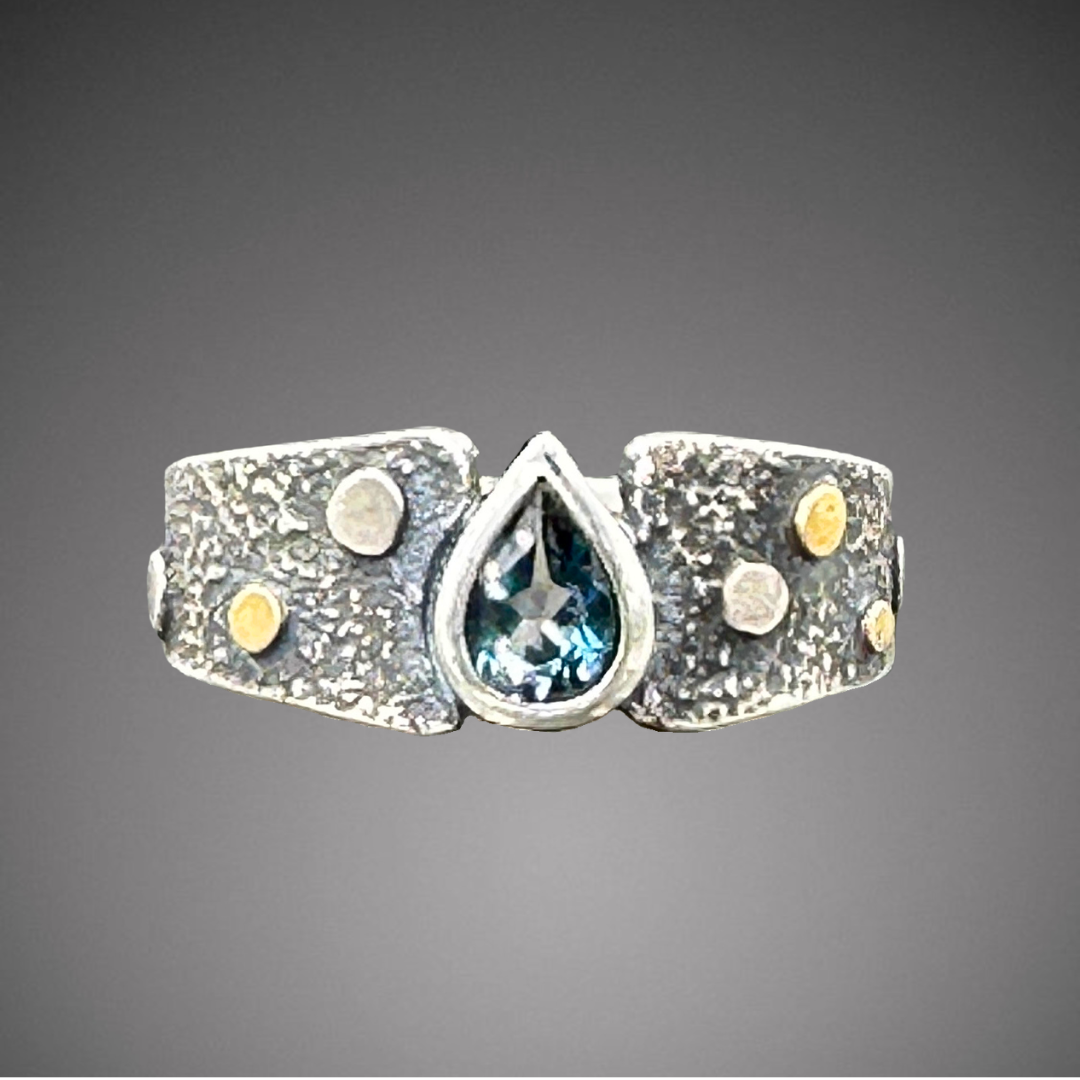 Blue Topaz on Pebble texture band with 22k