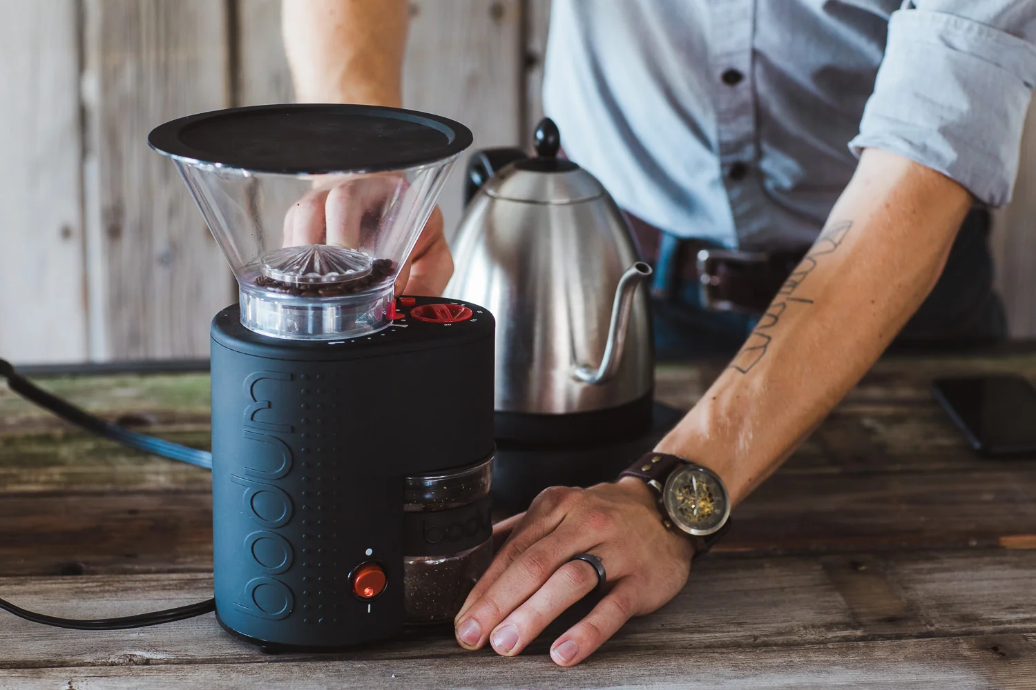 Barista using the Bodum Electic Coffee Burr Grinder