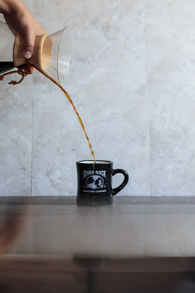 Pour coffee into a warmed coffee mug