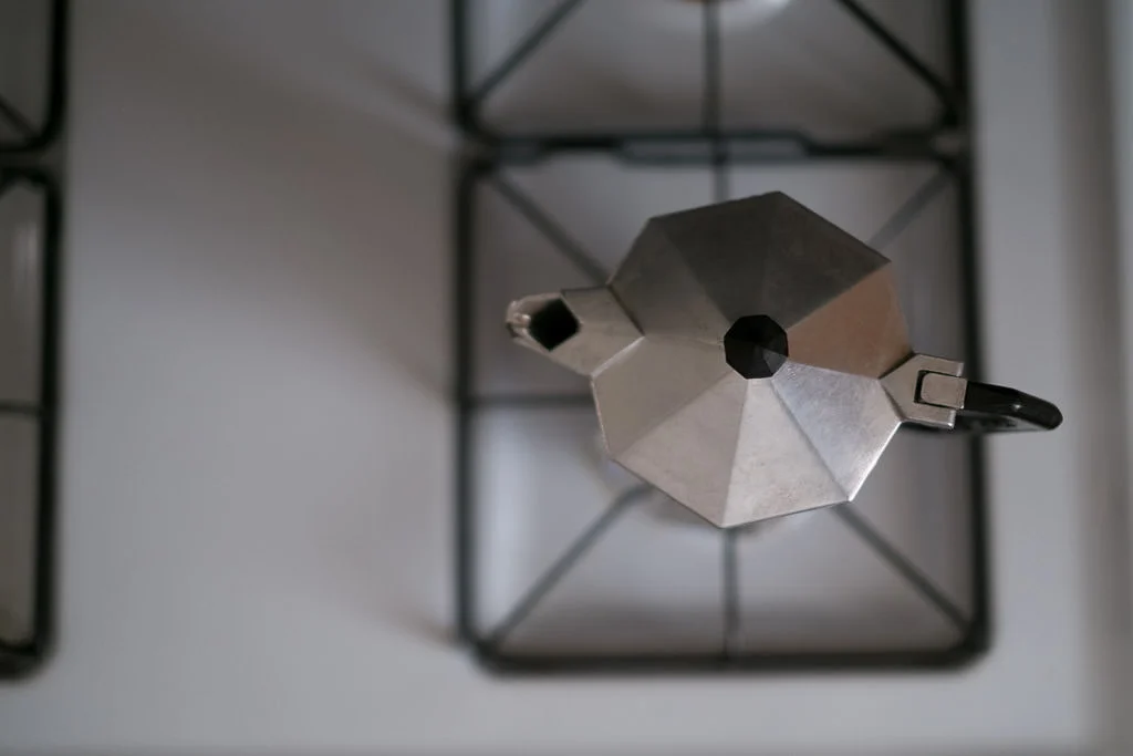 Moka pot espresso maker on stove top burner