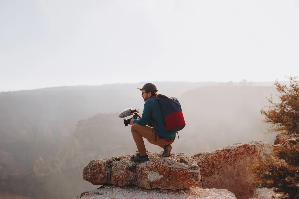 Videographer wearing cotopaxi backpack at Grand Canyon